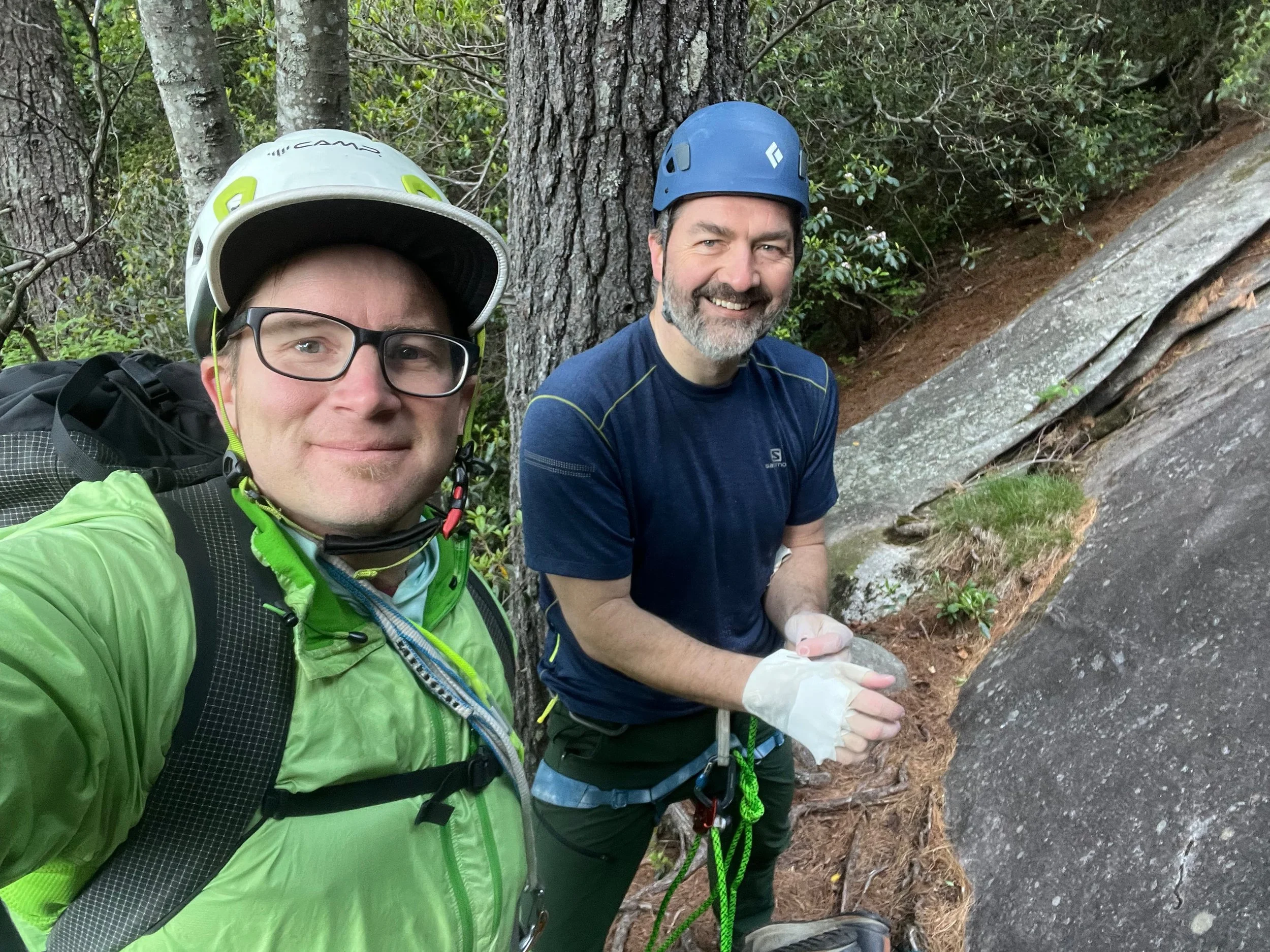 Happy climbers at the base of a rock climb.