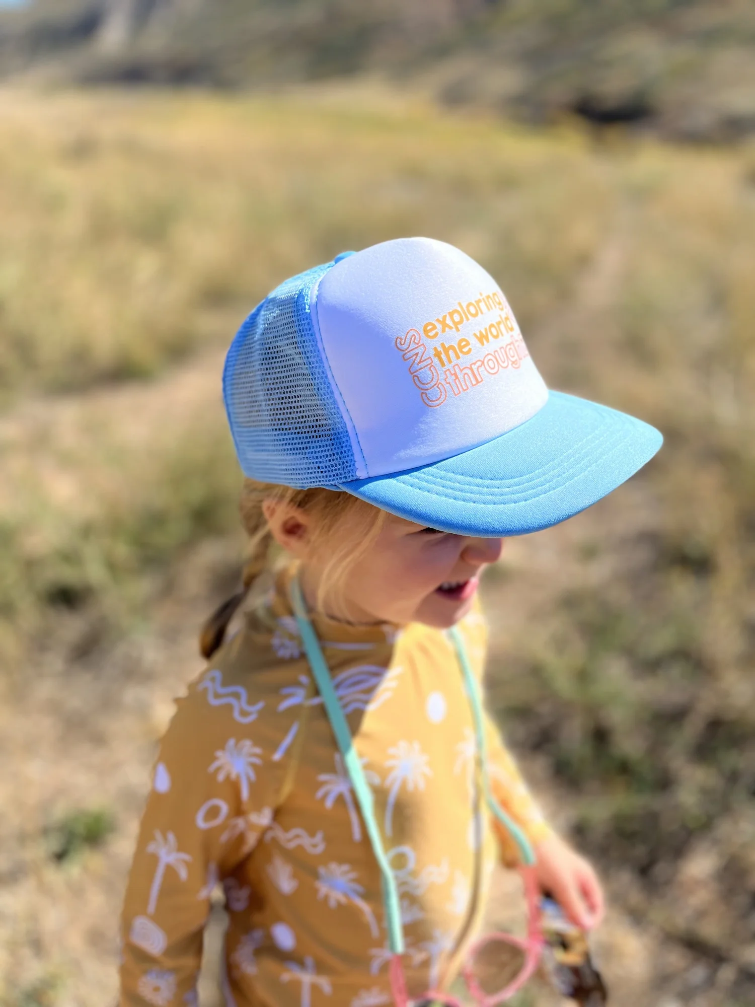 Exploring the world through play kids trucker hat — CCNS SLC