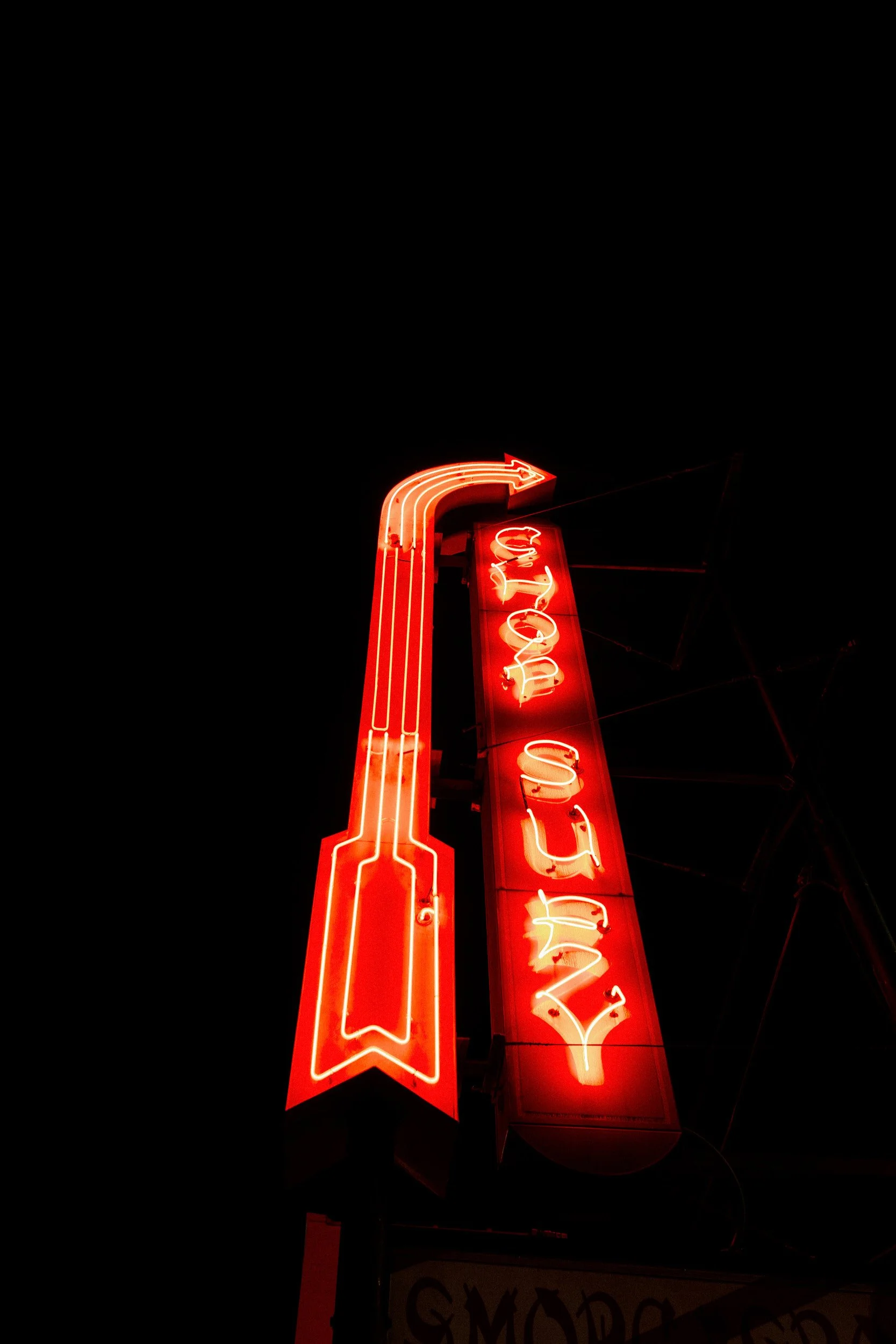 A vintage style neon sign lit up at night 