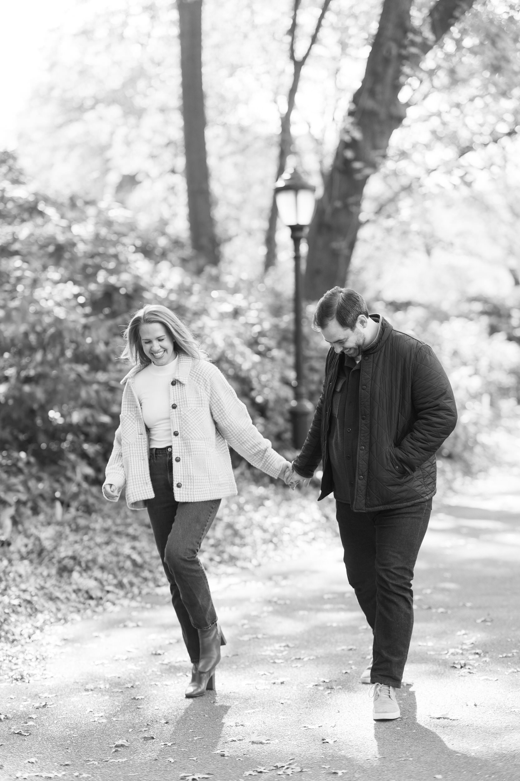 A couple holding hands and walking in a park 