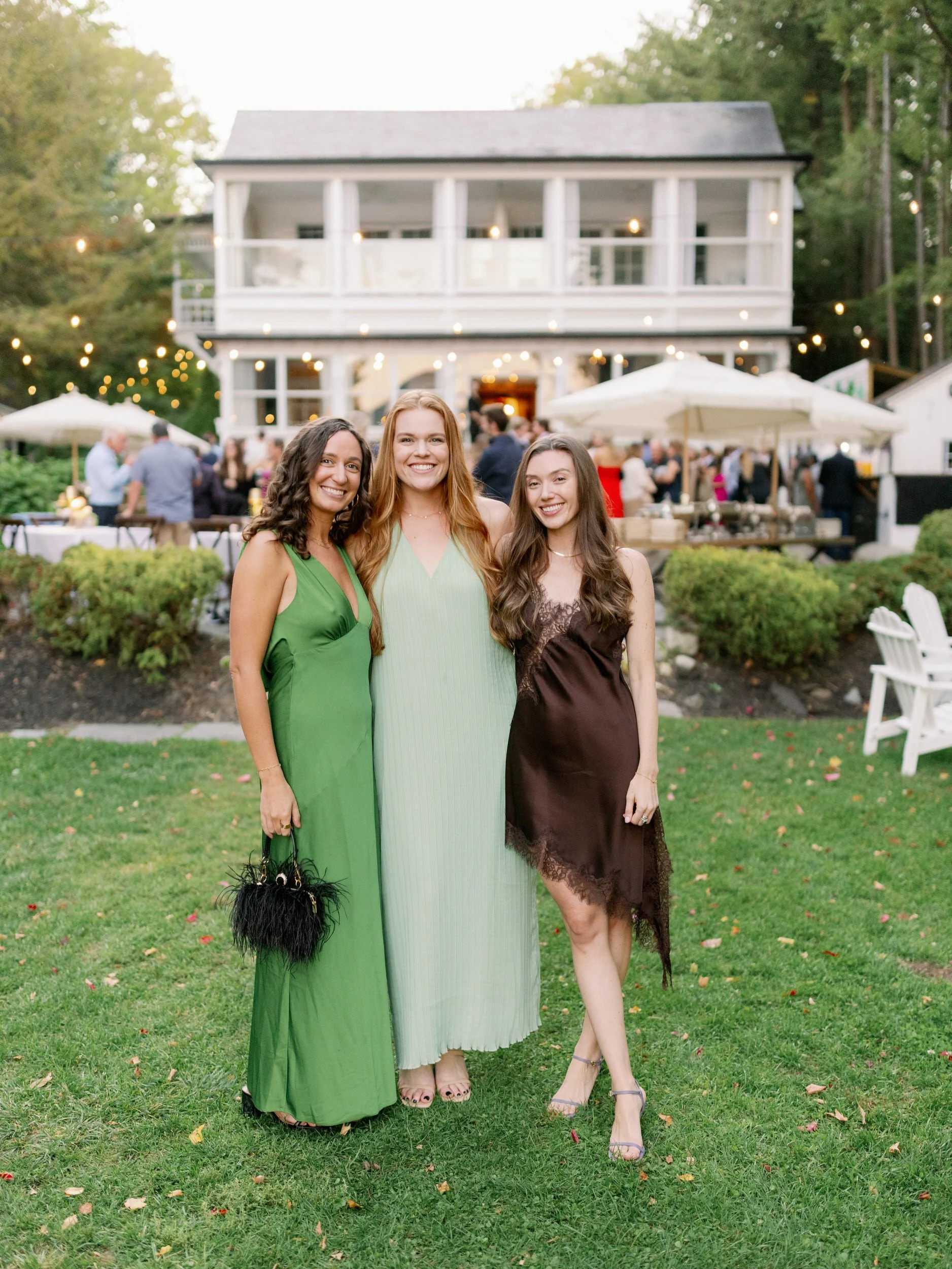 Wedding guests with their arms around each other smiling 