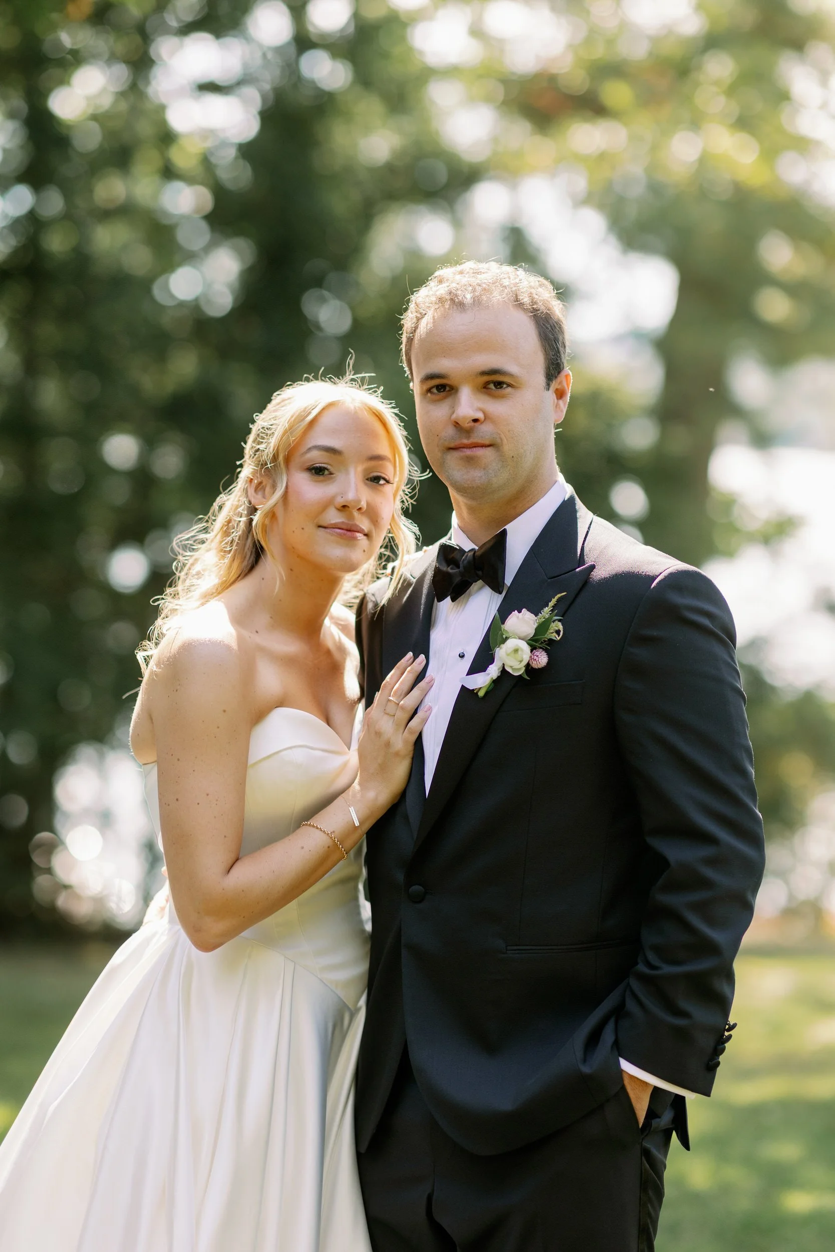 a newlywed couple standing close together and smiling 