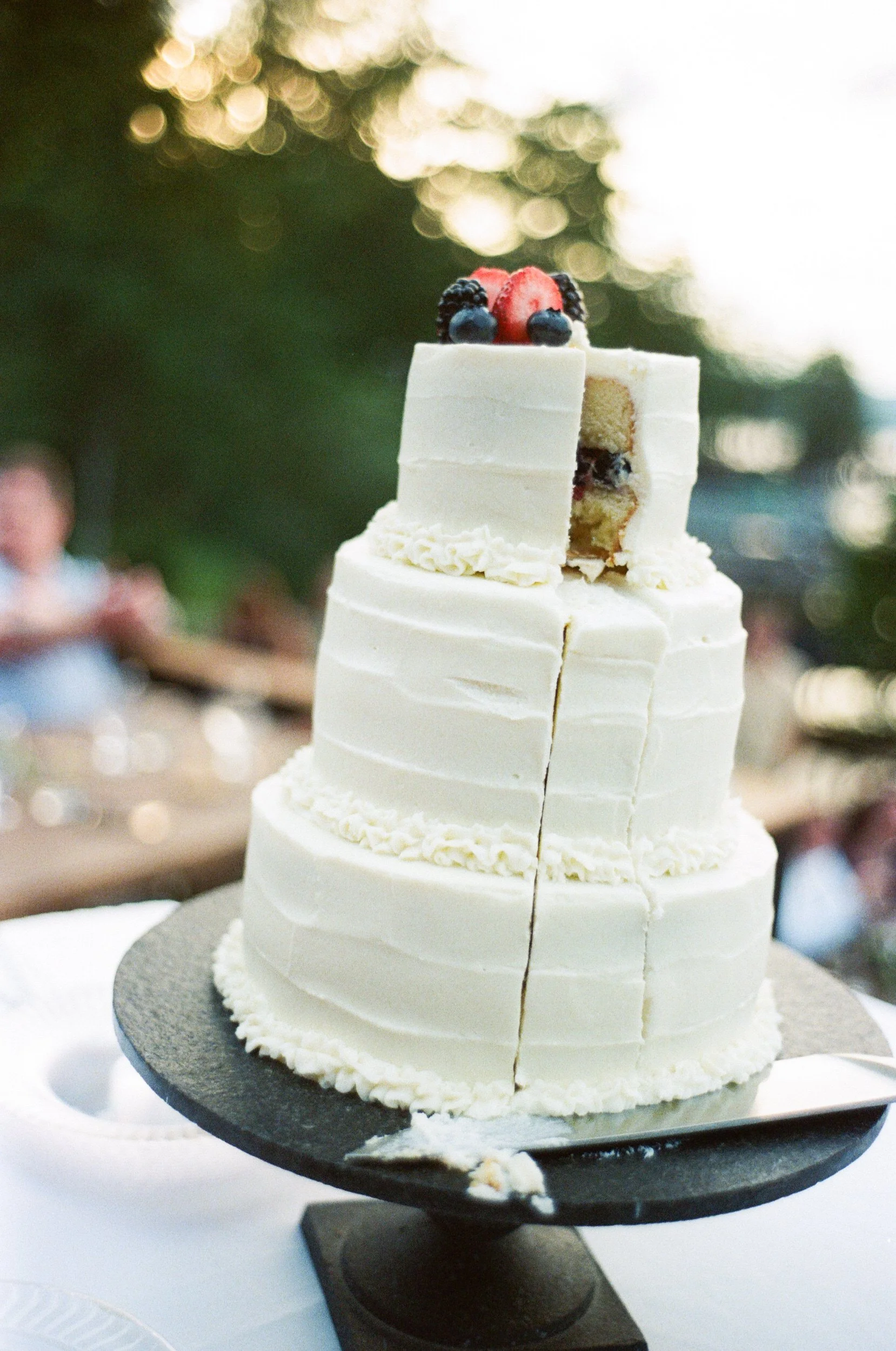 A small piece cut out of the top of a wedding cake 