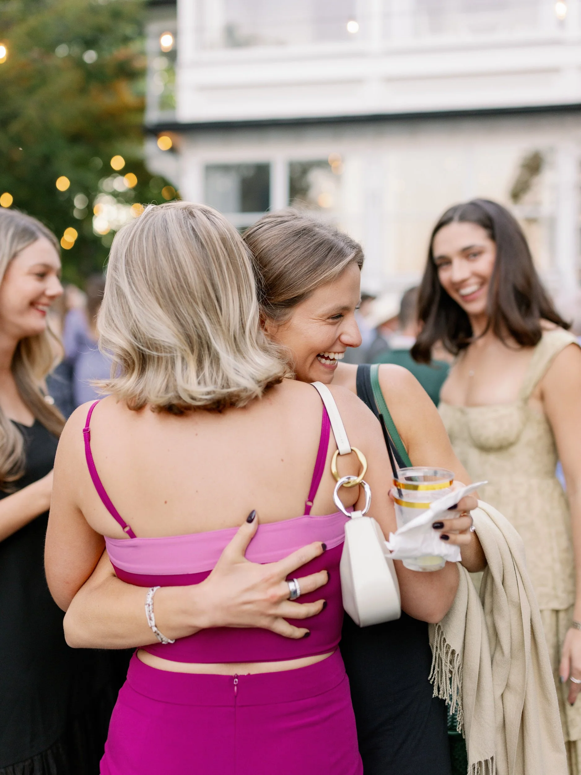 Wedding guests hugging and smiling 
