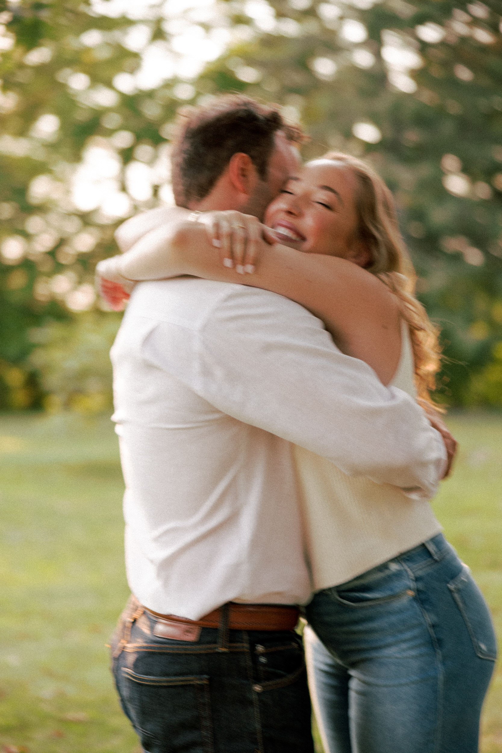 A person hugging their partner tightly and smiling