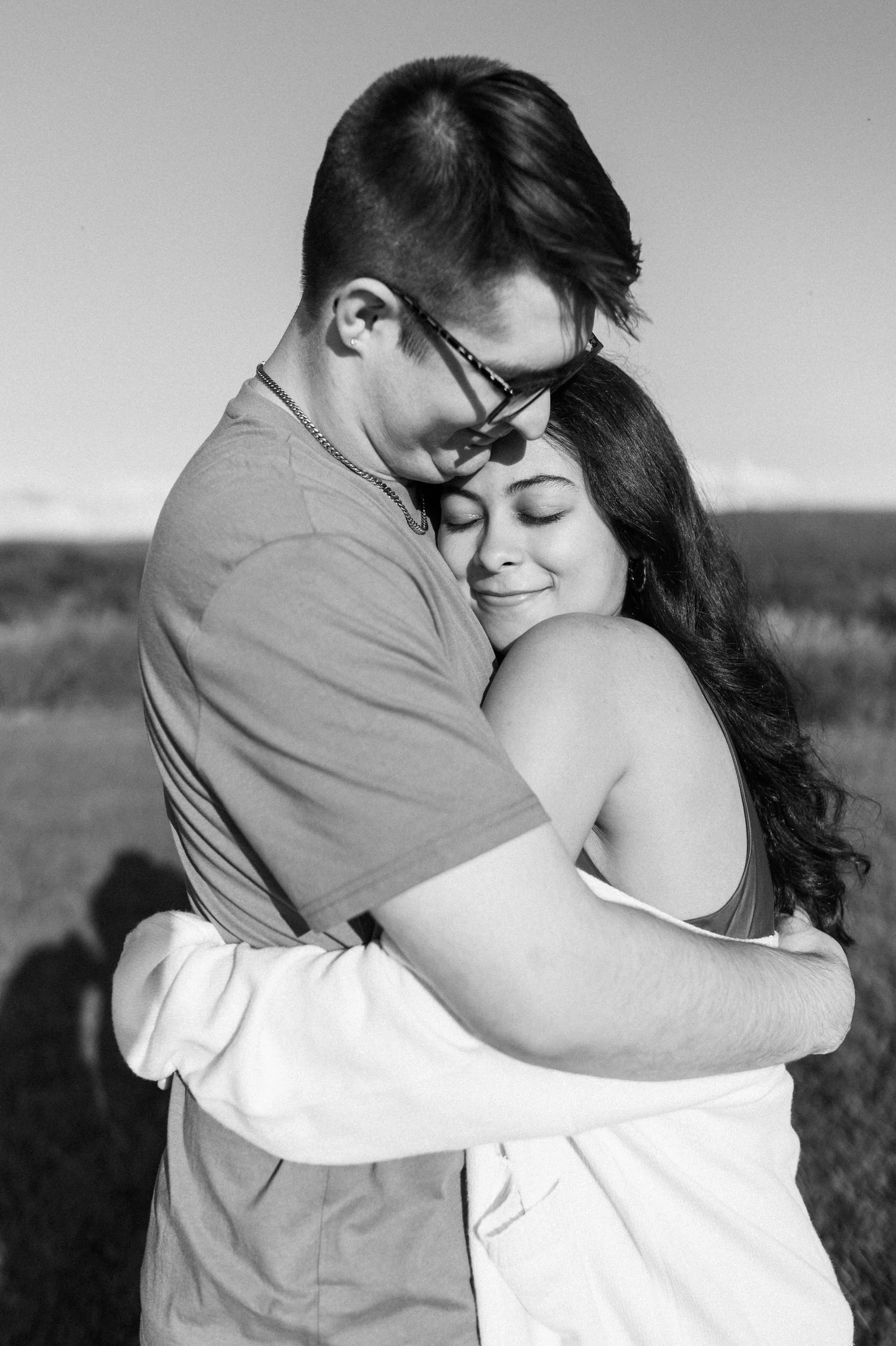 A couple tightly hugging each other 