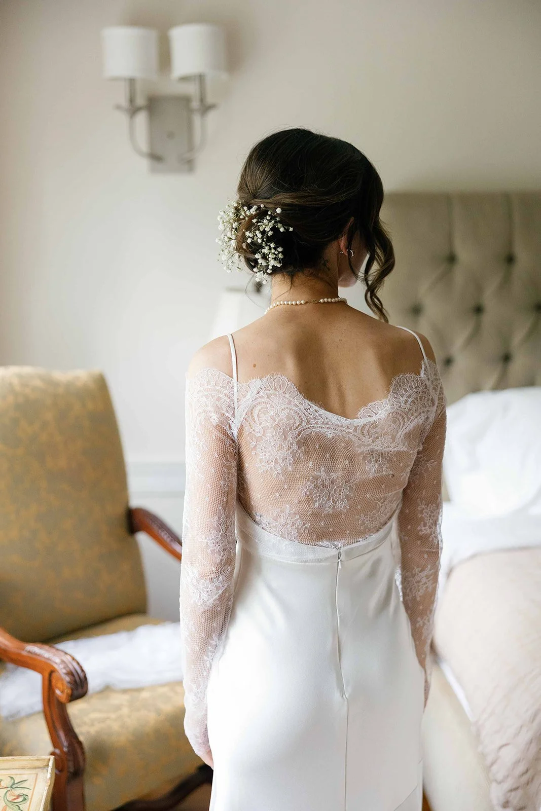 The back of a person in a white wedding dress 
