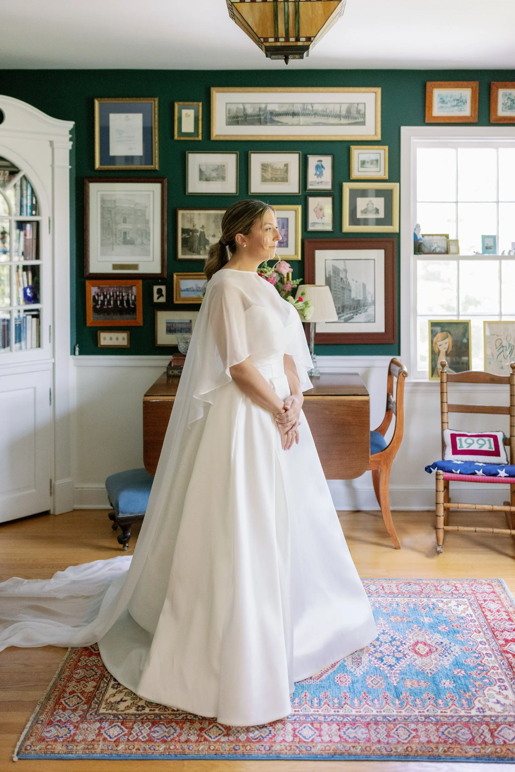 A person in a wedding dress standing in a vintage style room 