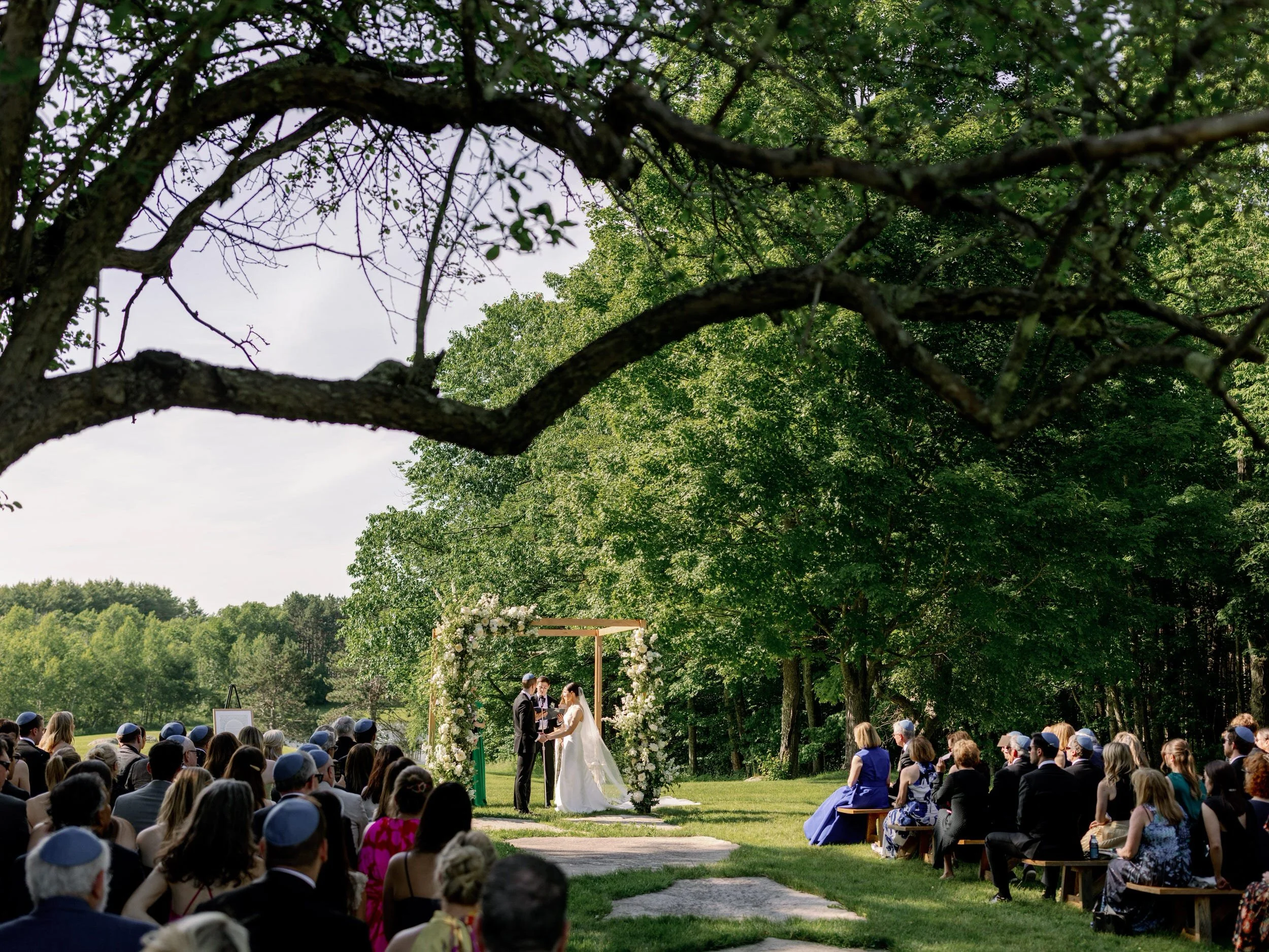 Newlyweds holding hands as they say their vows during their wedding