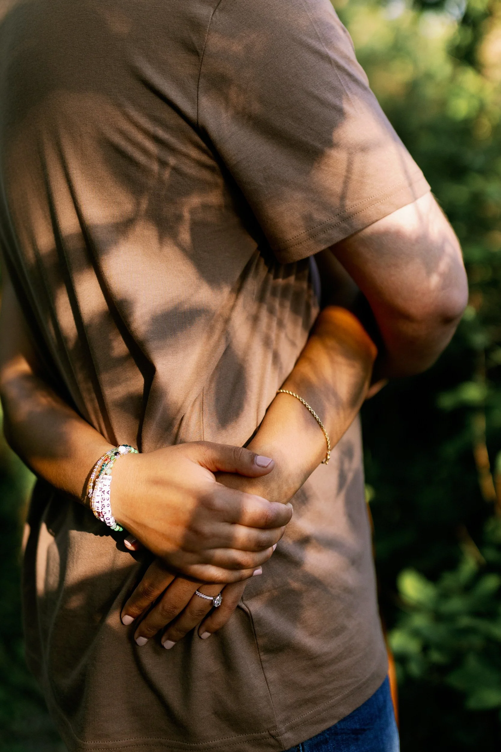 A close up of someone's hands around their partner's waist 