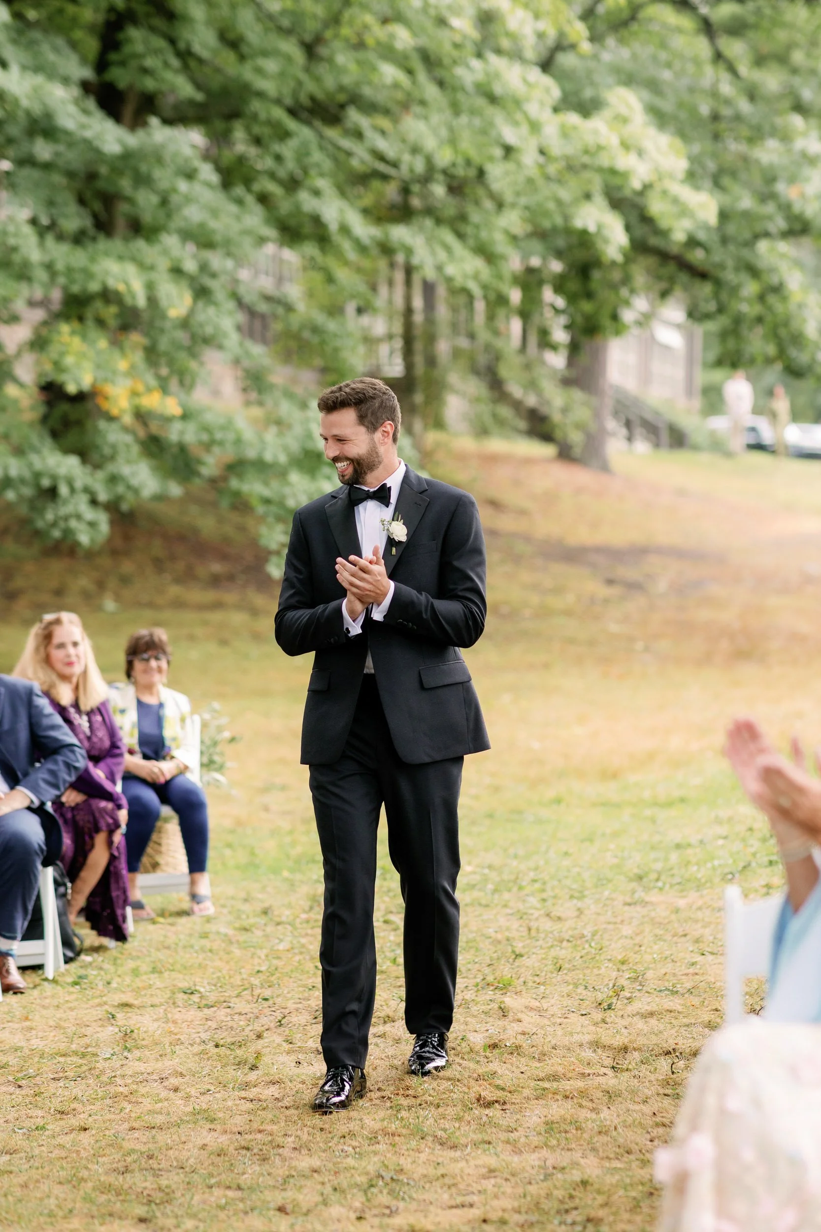 A person in a suit walking down the aisle before their wedding 