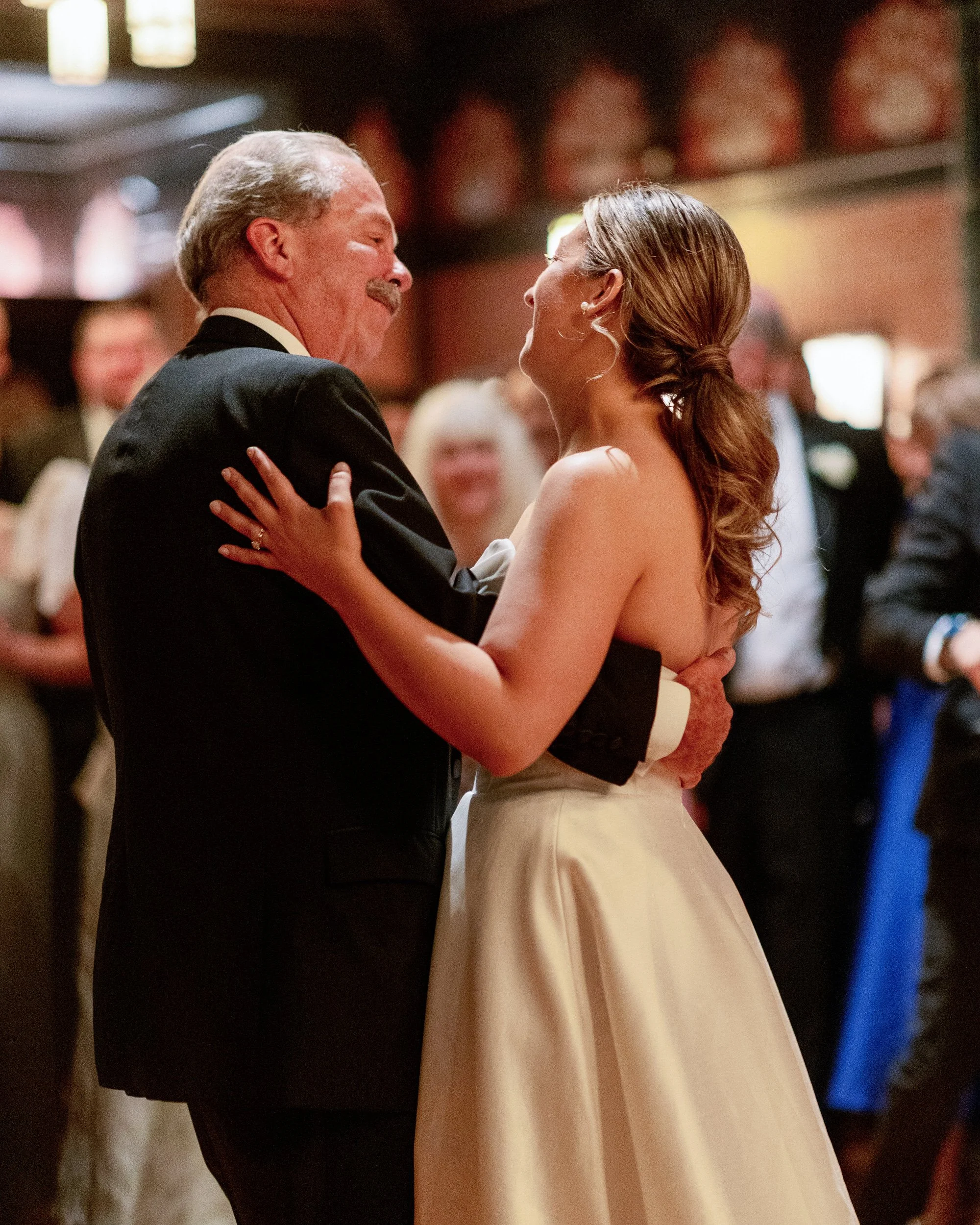 A newlywed dancing with their parent during their wedding ceremony 