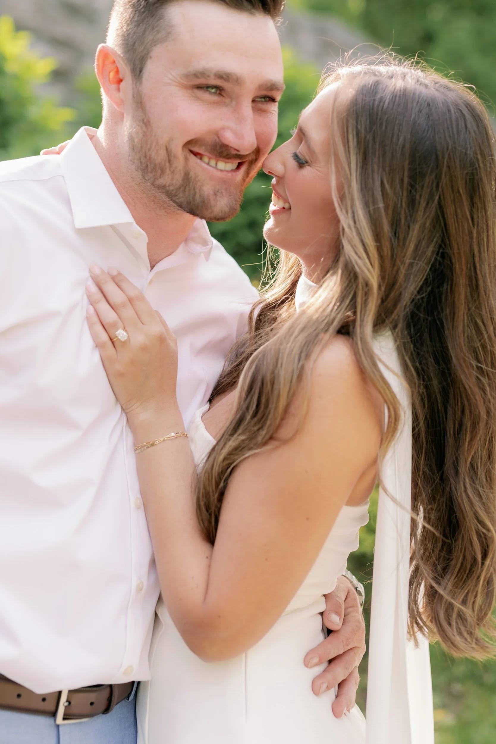 A person smiling at their partner with their hand on their chest 