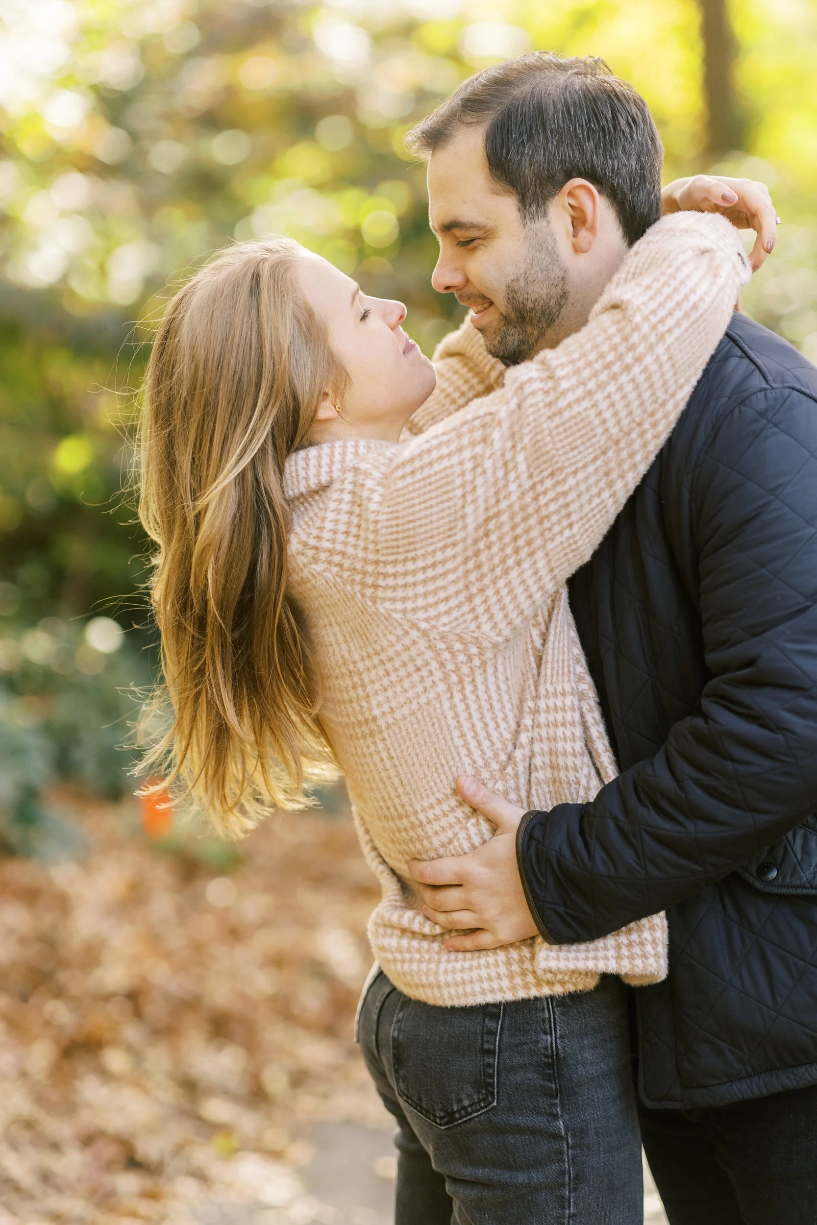 A couple with their arms around each other about to kiss