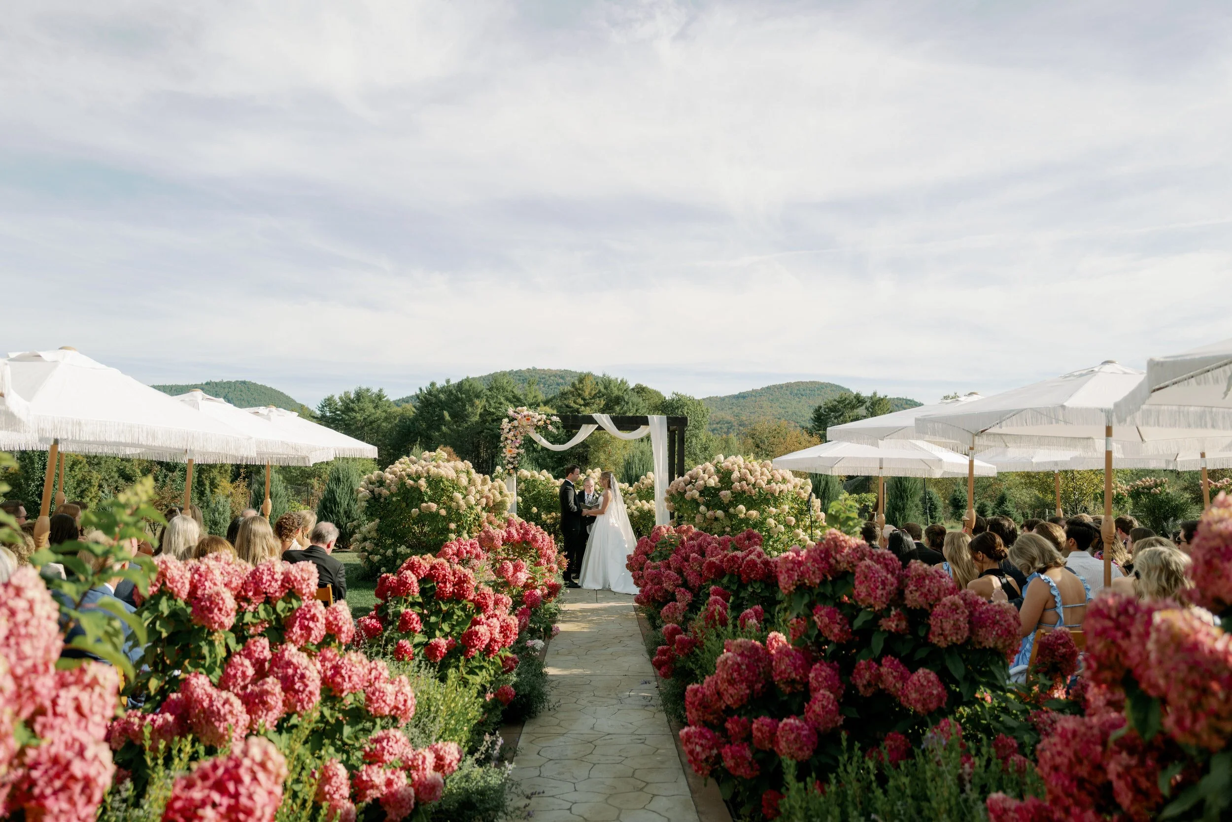 Newlyweds holding hands as they say their vows during their wedding ceremony