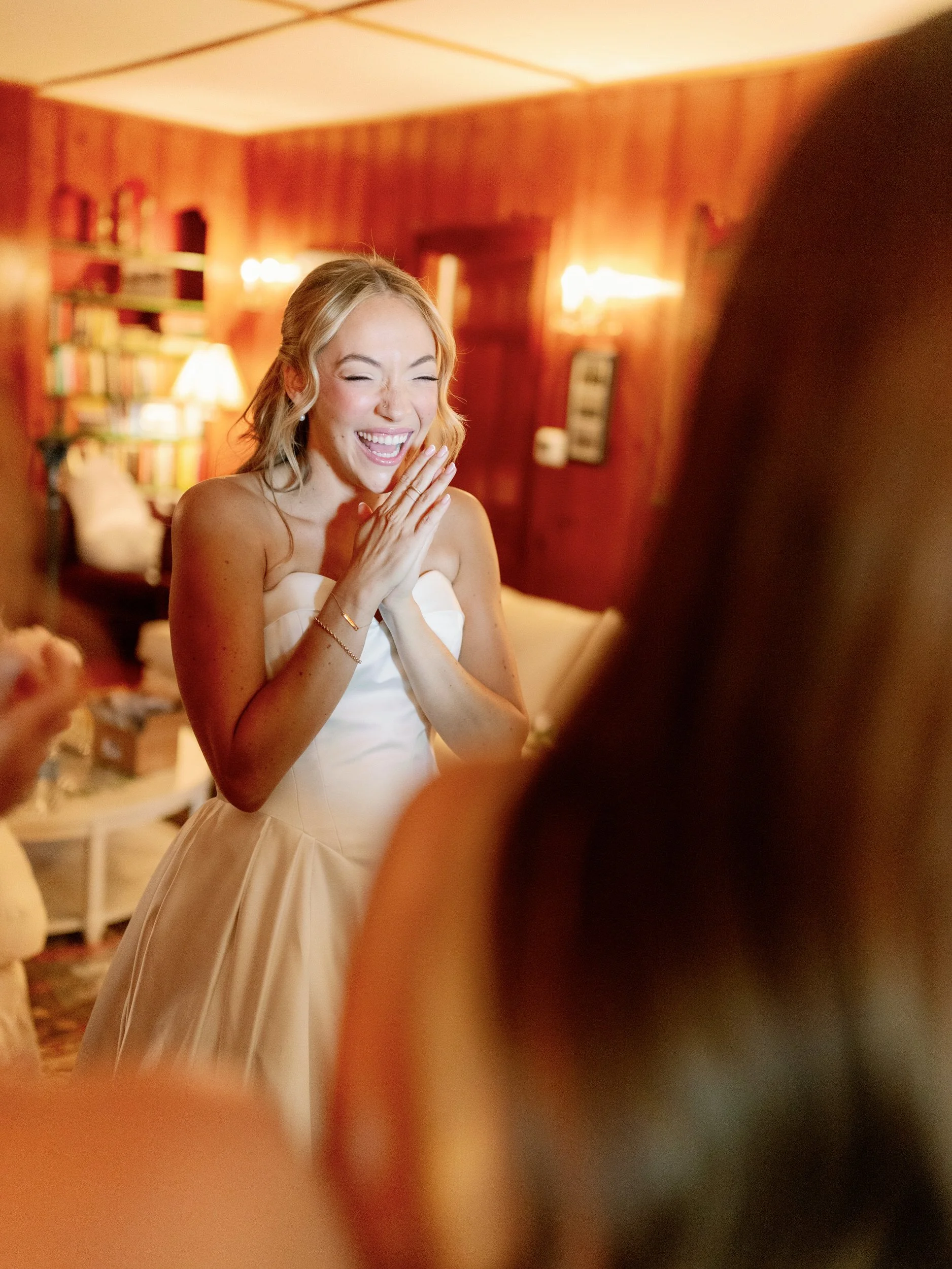 a person in a wedding dress with a big smile on their face 