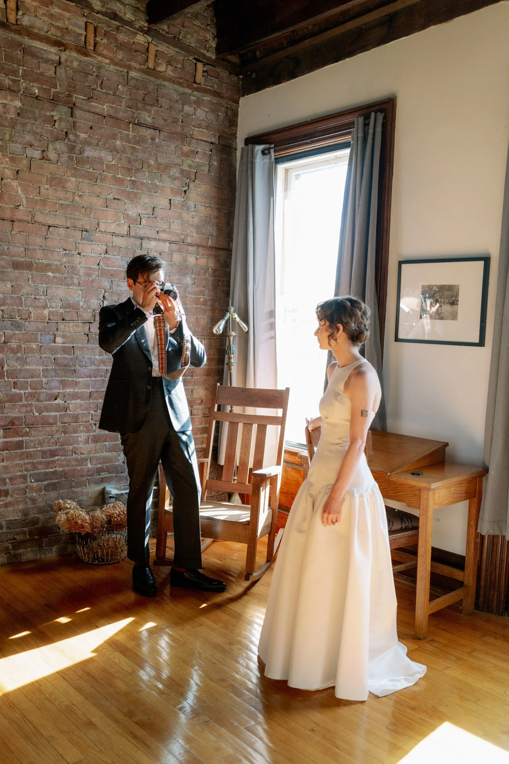 A newlywed taking a picture of their partner