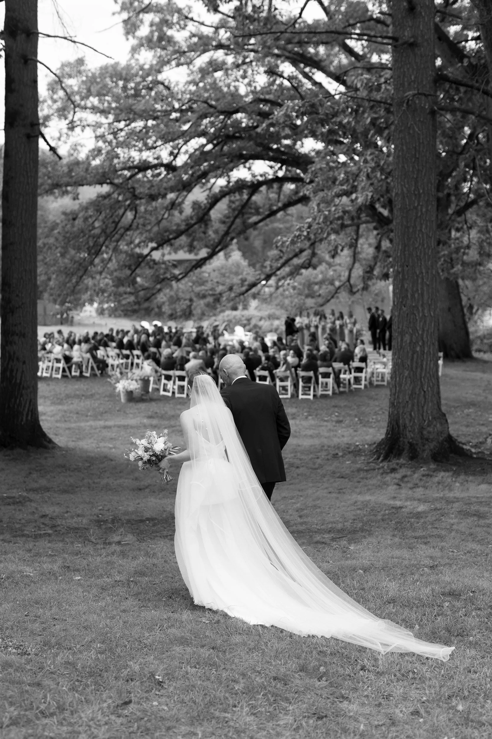 A parent walking their child down the aisle during their wedding