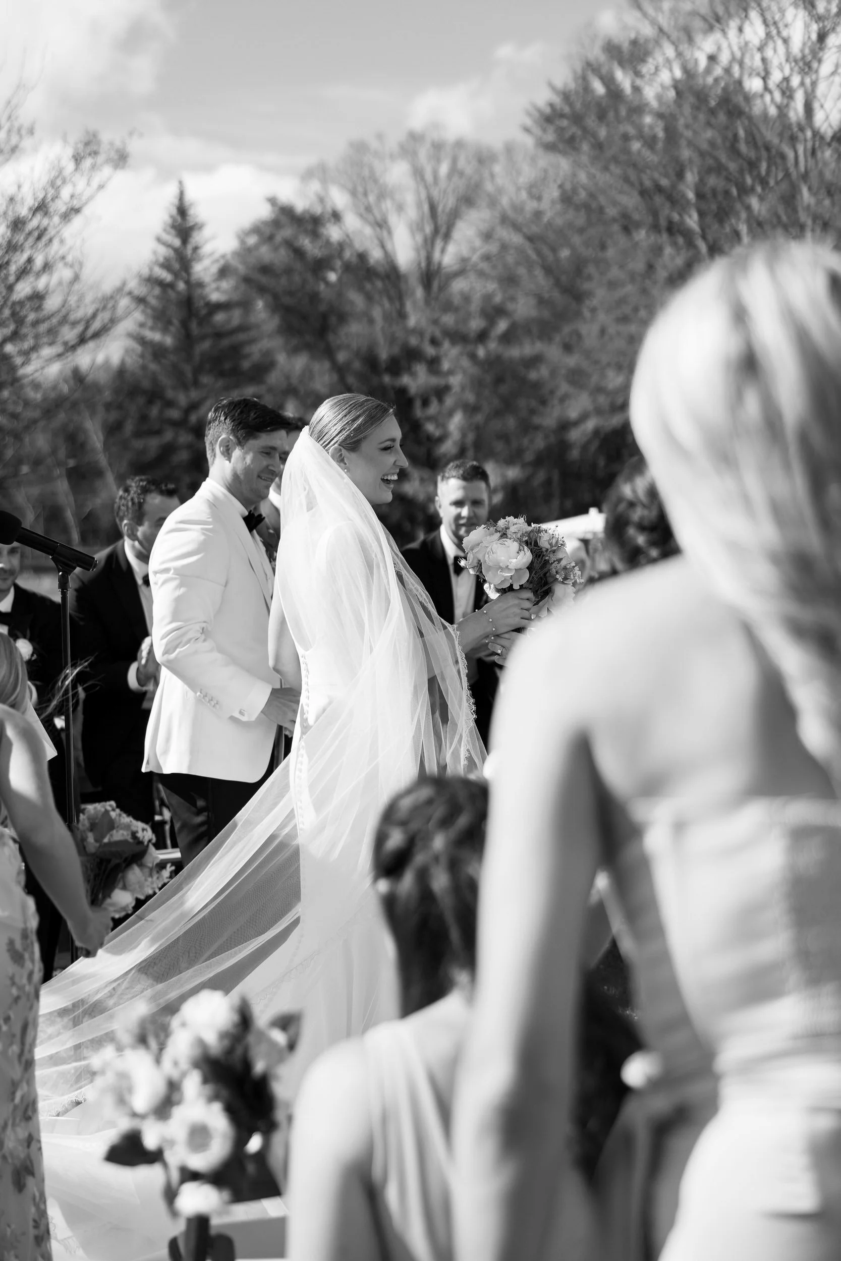 Newlyweds smiling as they walk back up the aisle after their wedding