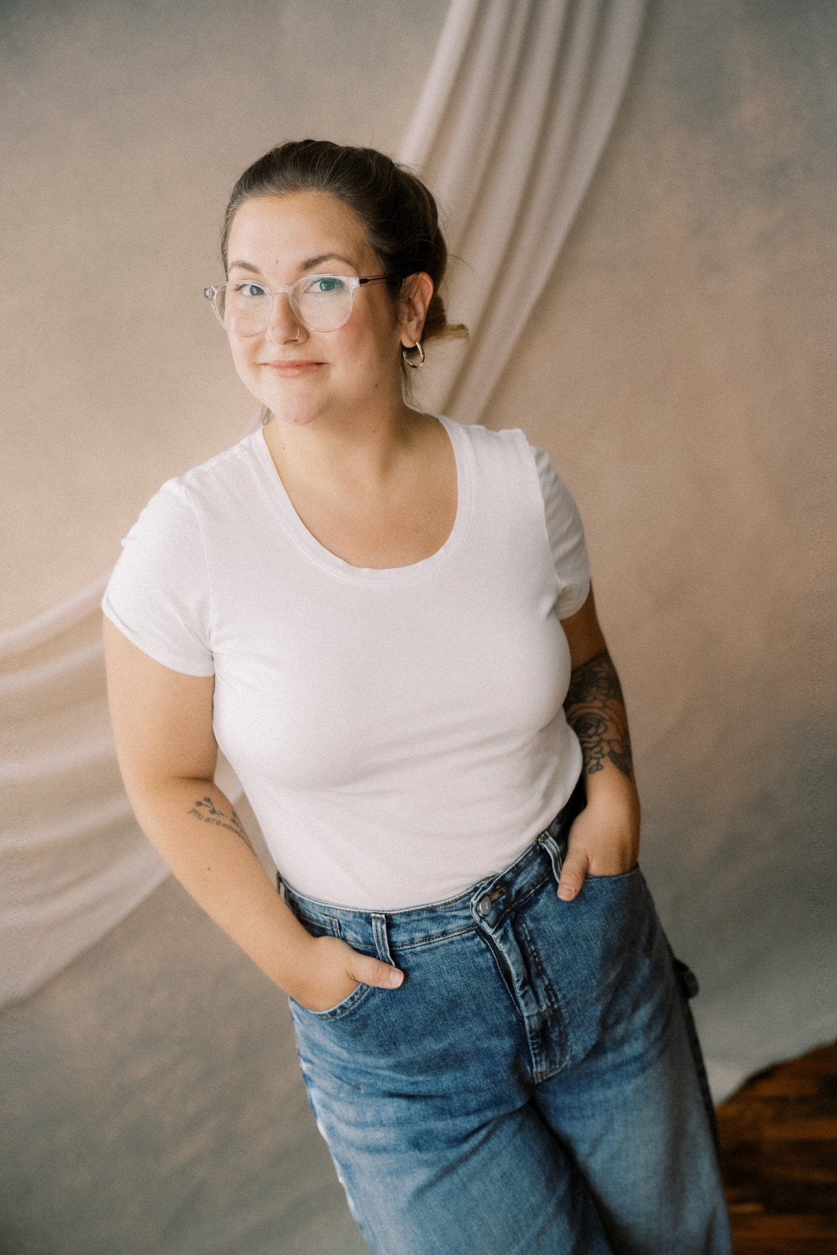 Maisie smiling with her hands in her pockets