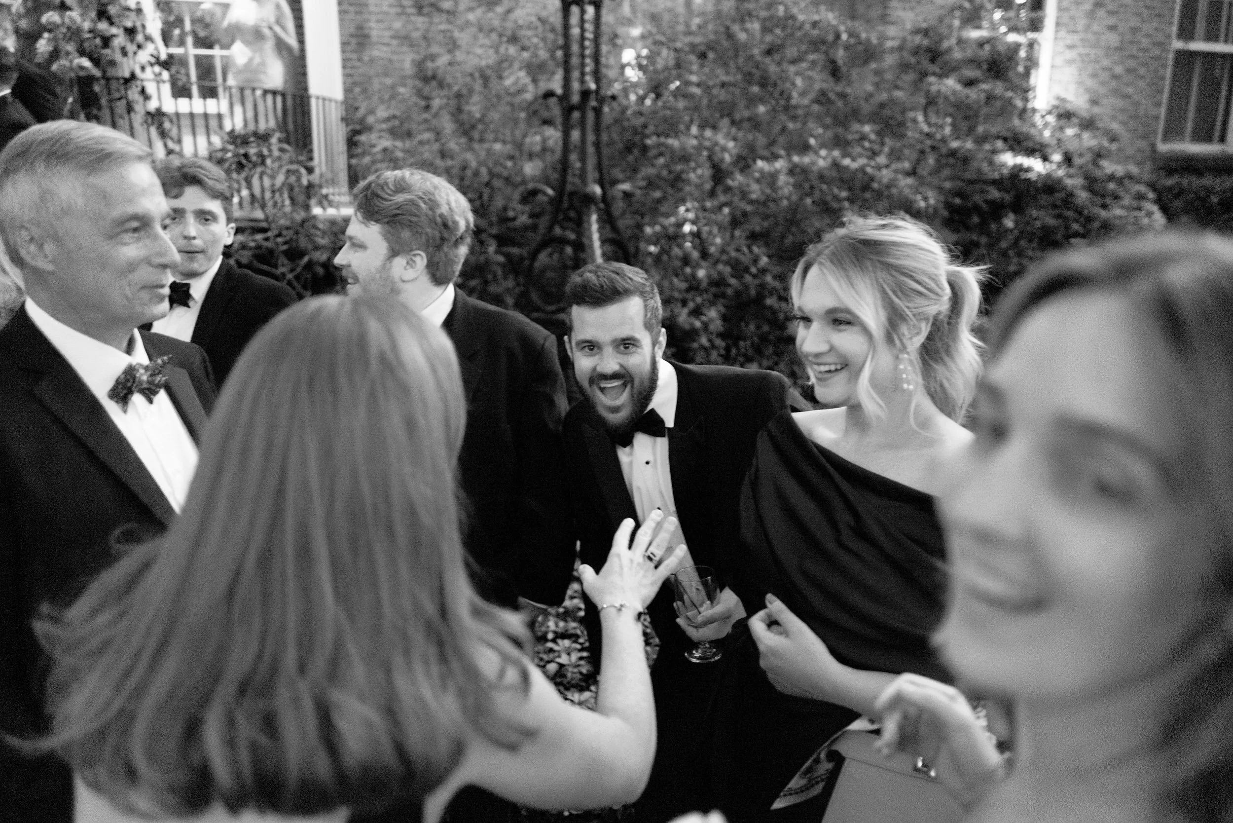 Wedding guests talking and laughing during a reception 