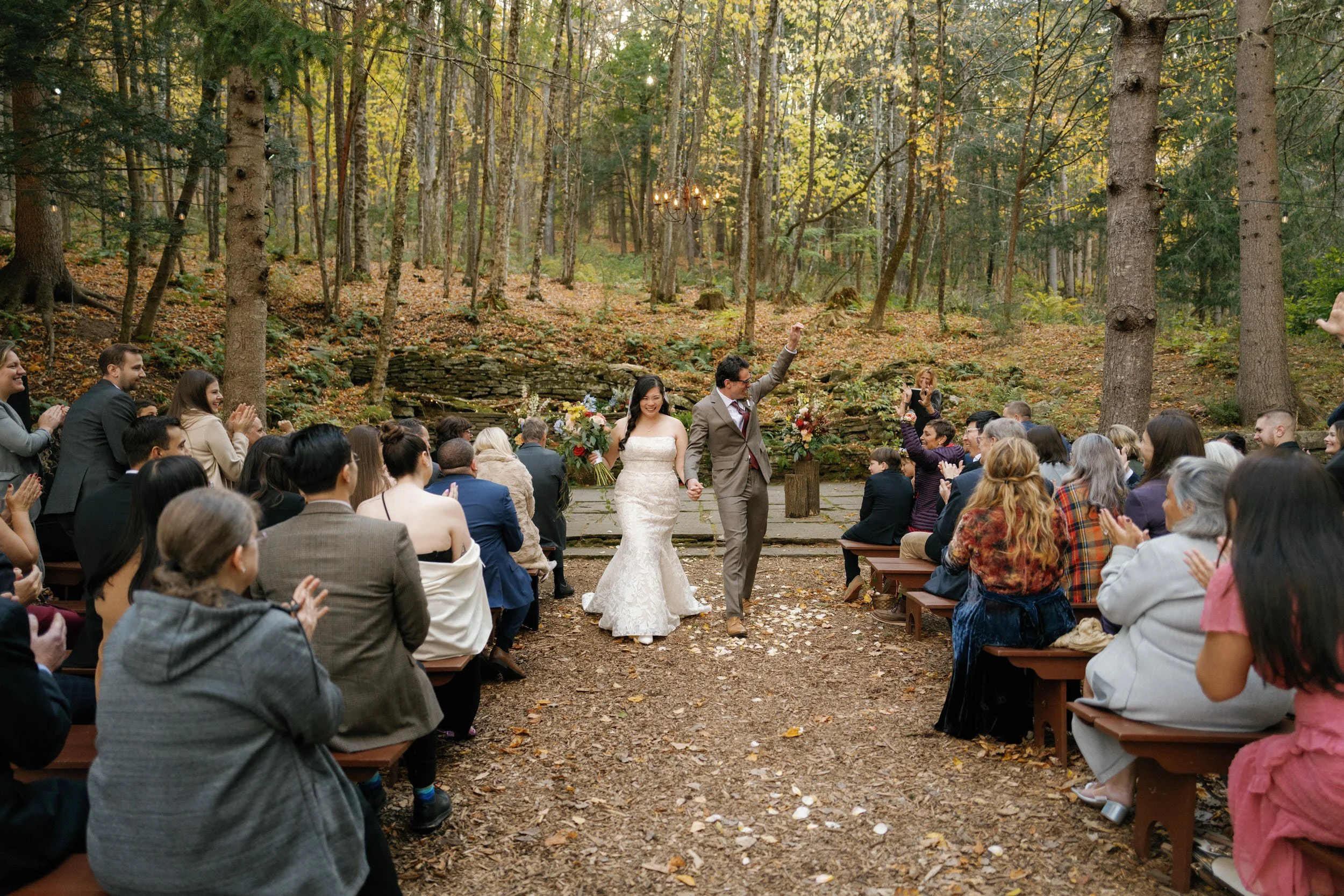 Newlyweds holding hands and walking back up the aisle after their wedding ceremony 