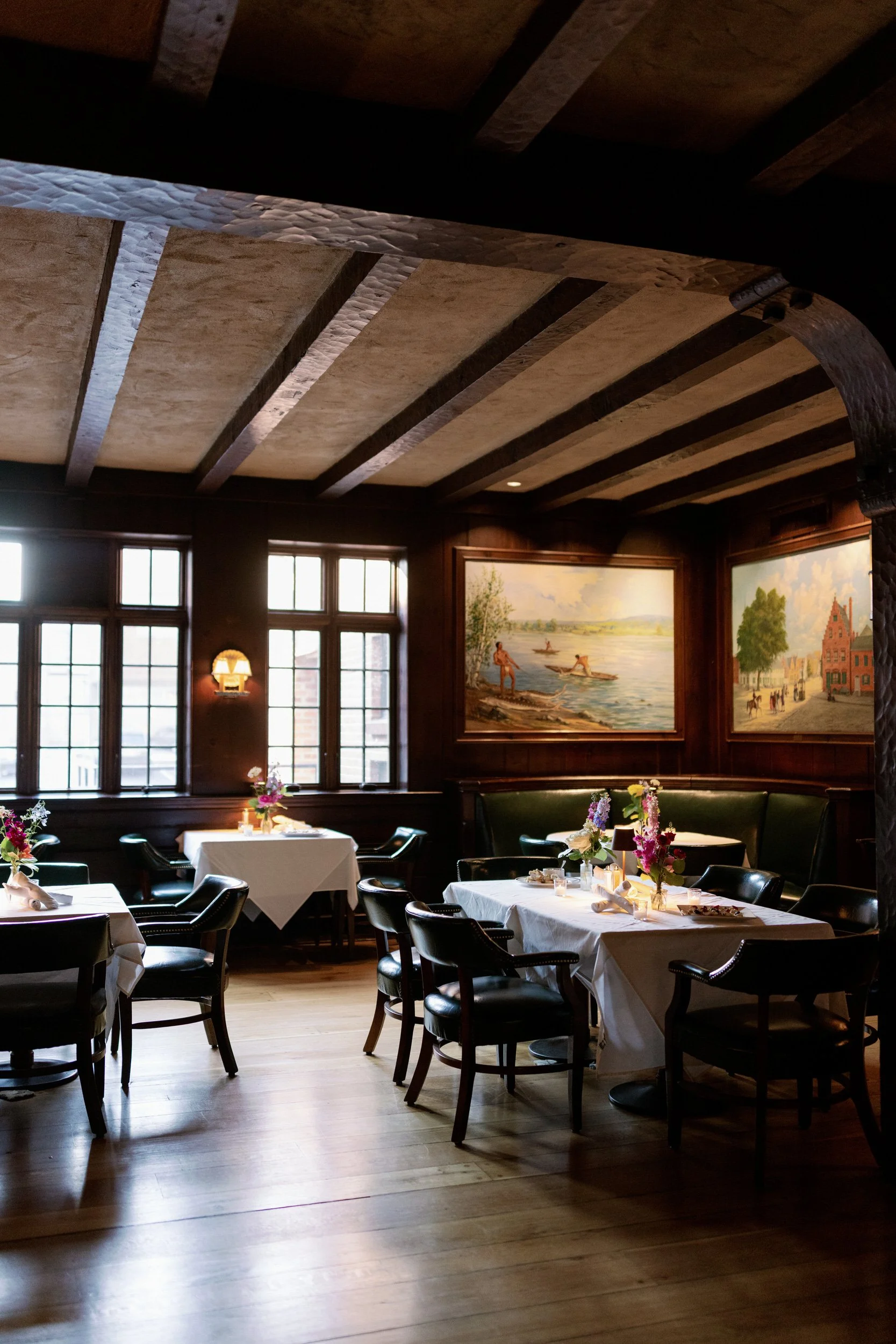 A small dining room with dark wood accents 