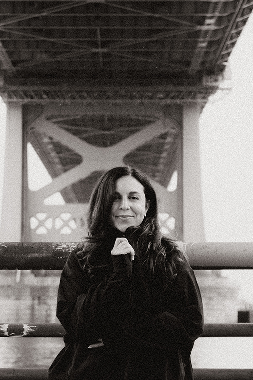 Woman in front of bridge