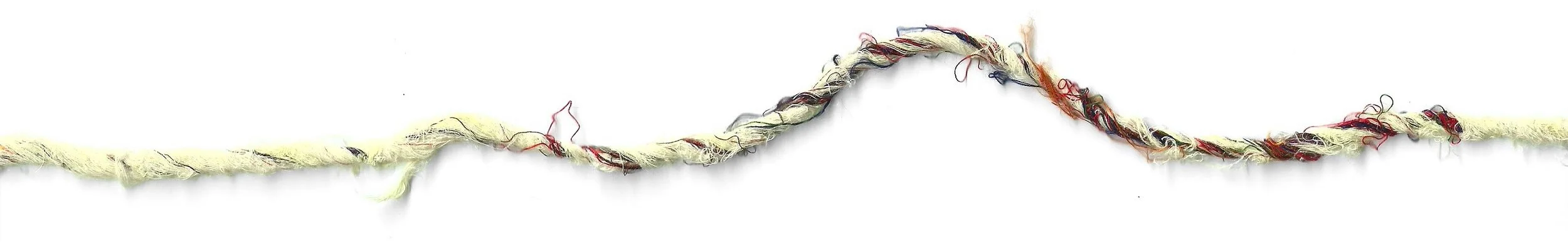 A horizontal strand of frayed, multicolored yarn with cream, red, black, and other colored fibers against a white background.