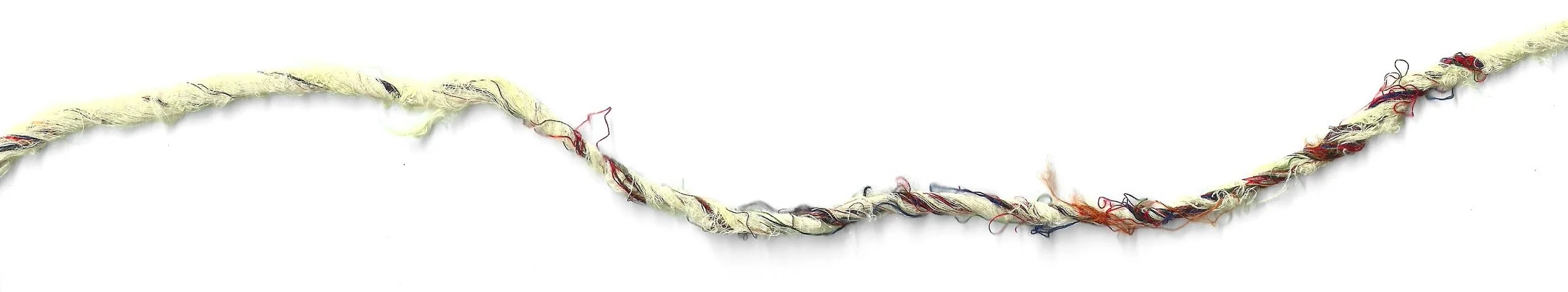 Close-up of a frayed, twisted, multicolored piece of string or yarn on a white background.