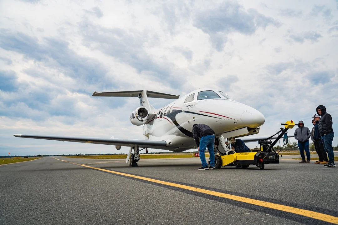Embraer Phenom 100 being towed on the ramp