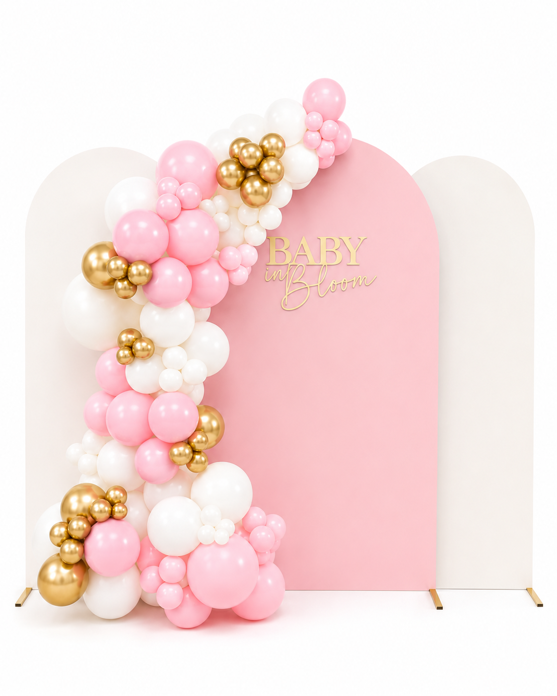 Pink and white balloon arch with gold accents in front of a pink backdrop that says "Baby in Bloom".
