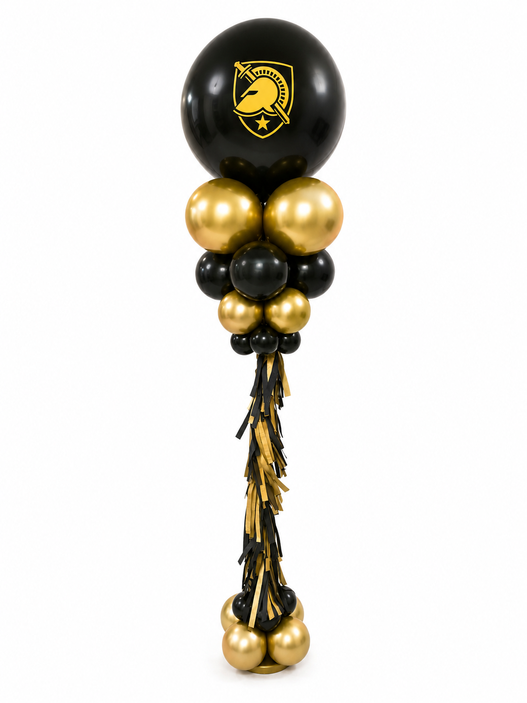 Tall balloon tower column with black and gold balloons, featuring a large black balloon with a custom gold University logo at the top, and black and gold fringe tassel hanging down the middle.