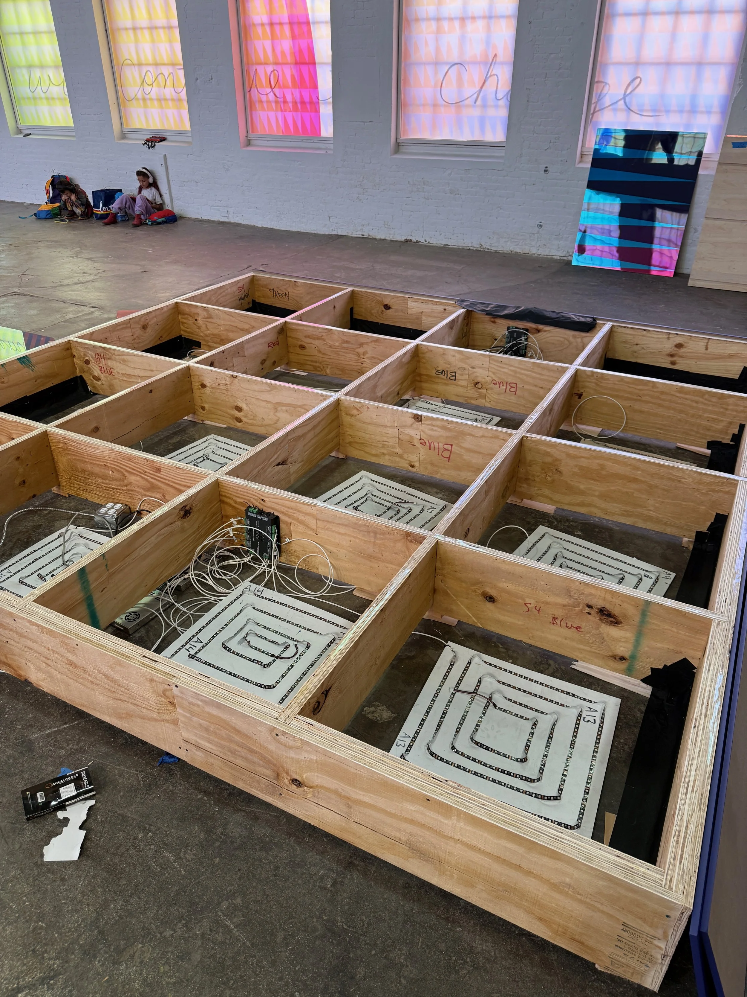 Process photo taken during the installation of Jeffrey Gibson's Power Full Because We're Different. 
I designed and fabricated 114 led panels to illuminate the glass stages.