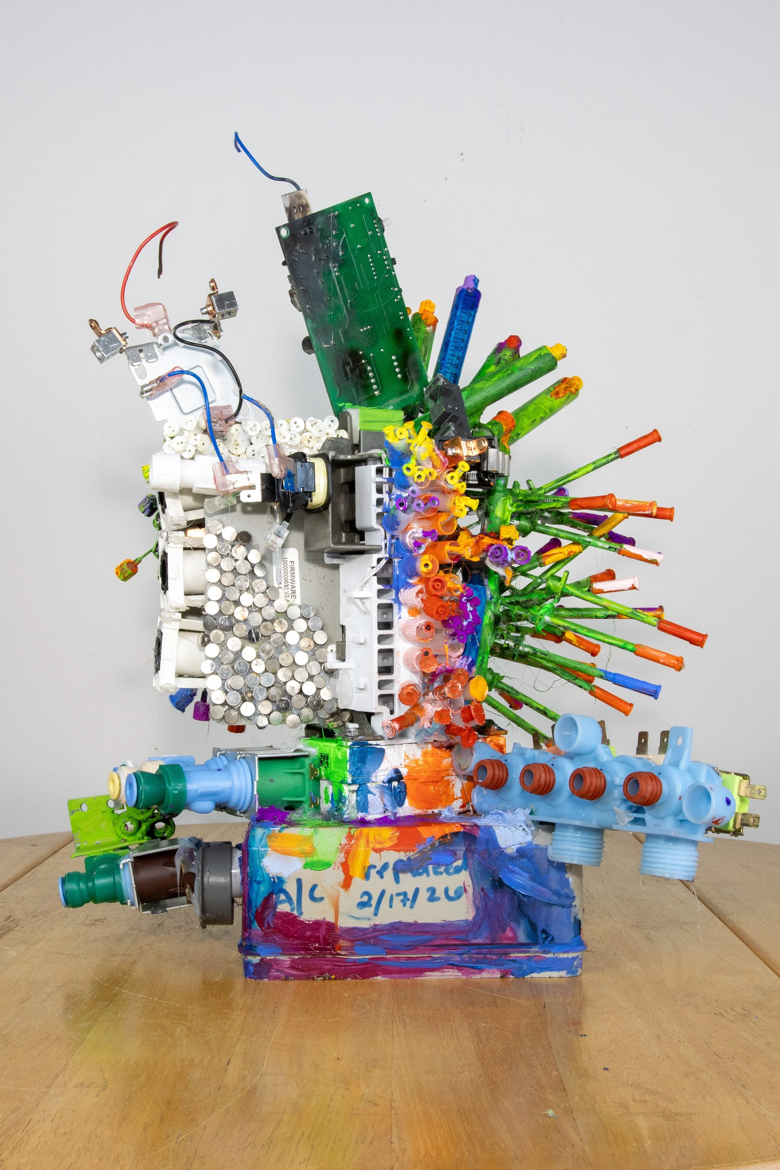 Redemption projects in nine photos items of detritus and trash no longer useful but which is in fact a compilation of accomplishments of modern life: electrical generator control box and parts, a circuit board which miniaturized a series of commands,