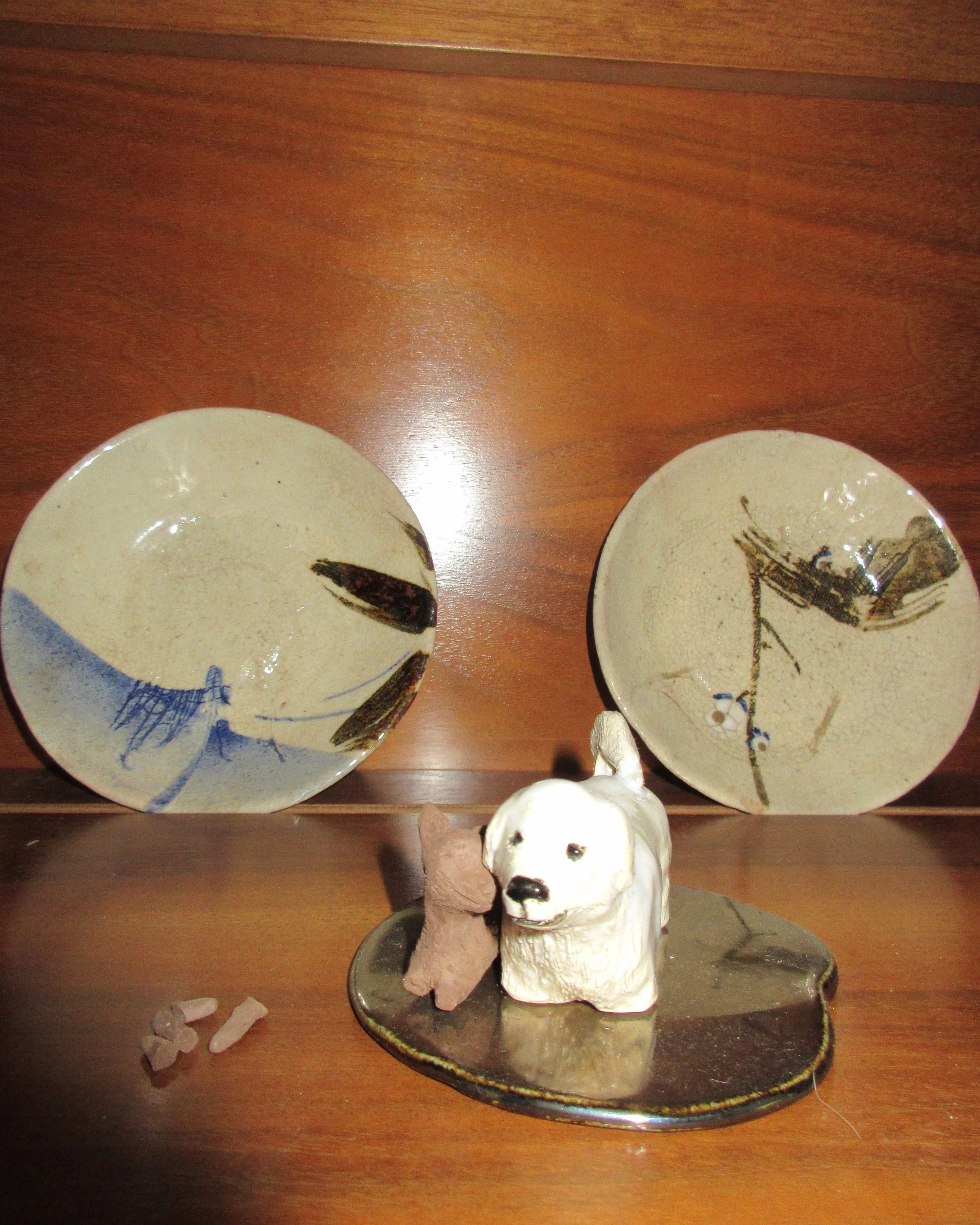 sadie’s late dog enzo sits camera right, pepper (crafted by sadie) leaning into him from the left, together on a portal.