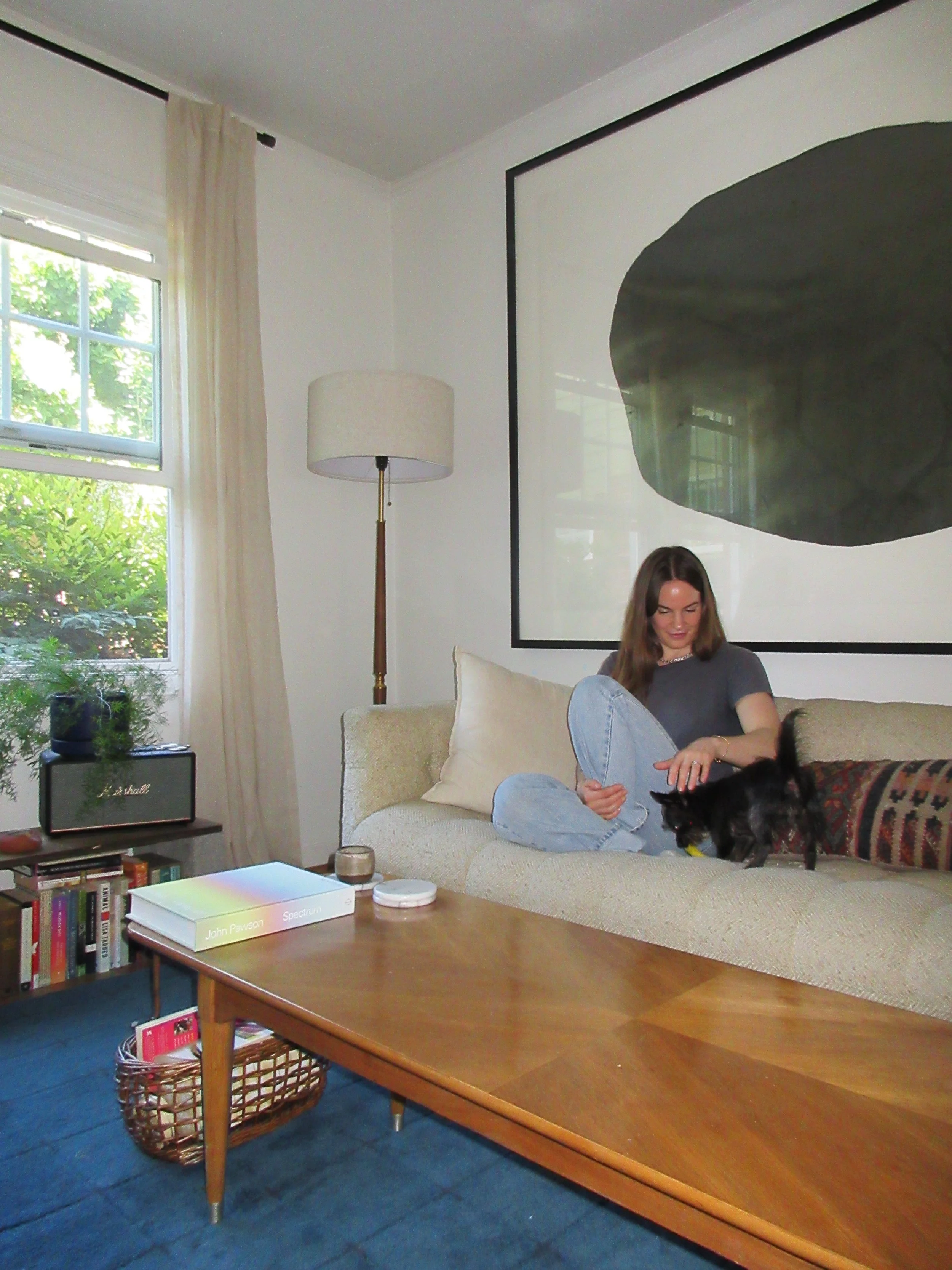 sadie & pepper play on the couch, sitting in their usual spot. behind them floats an original graphite piece from an artist friend of sadie’s, offering a portal for reflection. it feels simultaneously monolithic and unquestionably the exact right siz