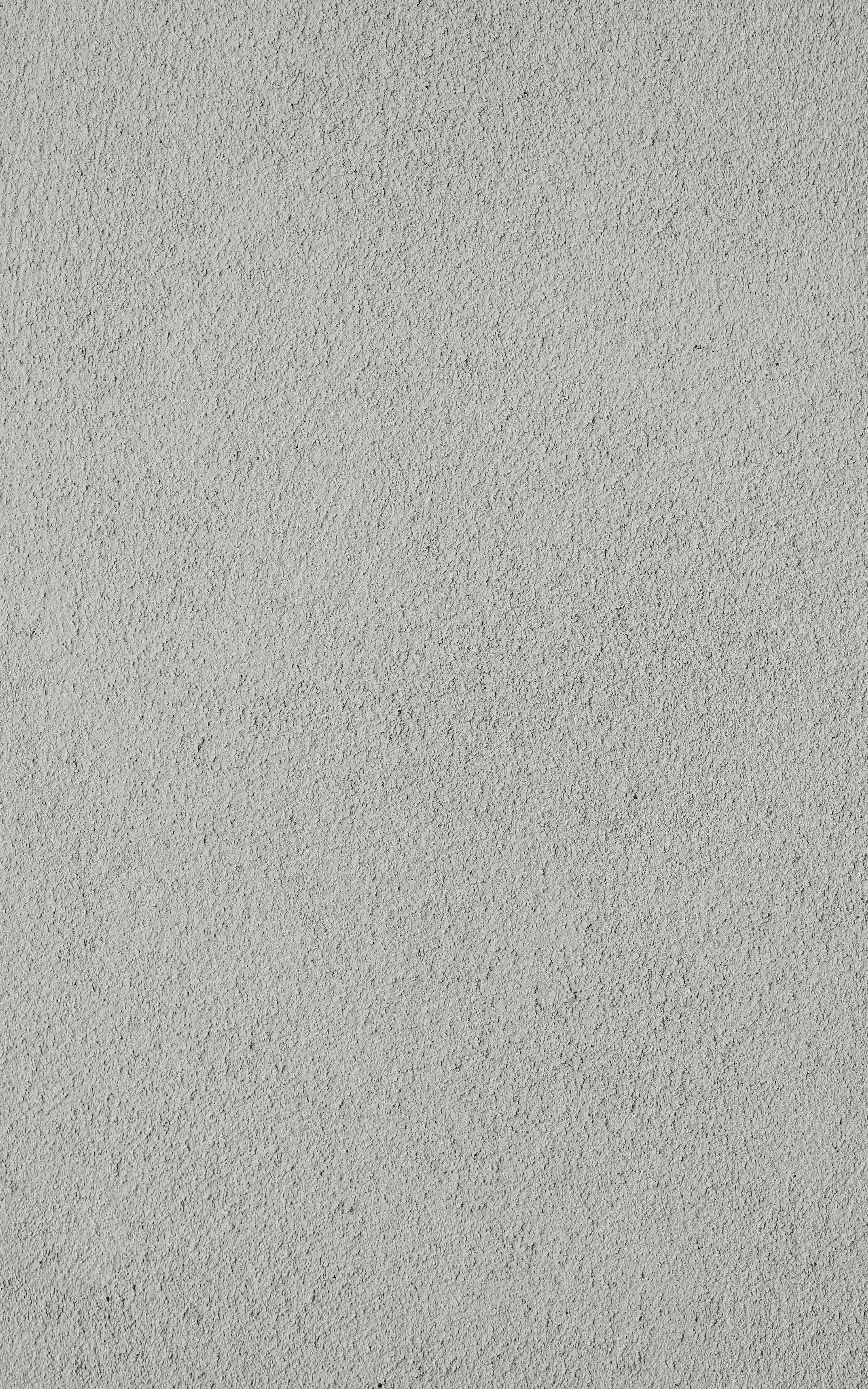 Close-up view of a light grey textured wall.