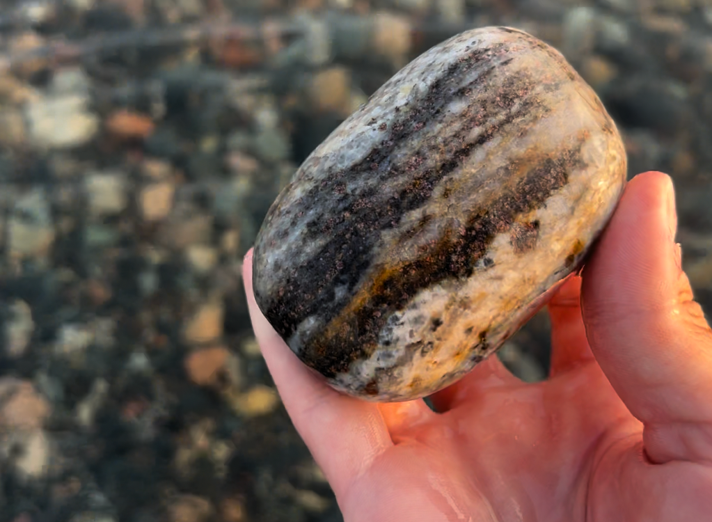 If the small purple crystals are garnet, this might be something called eclogite.