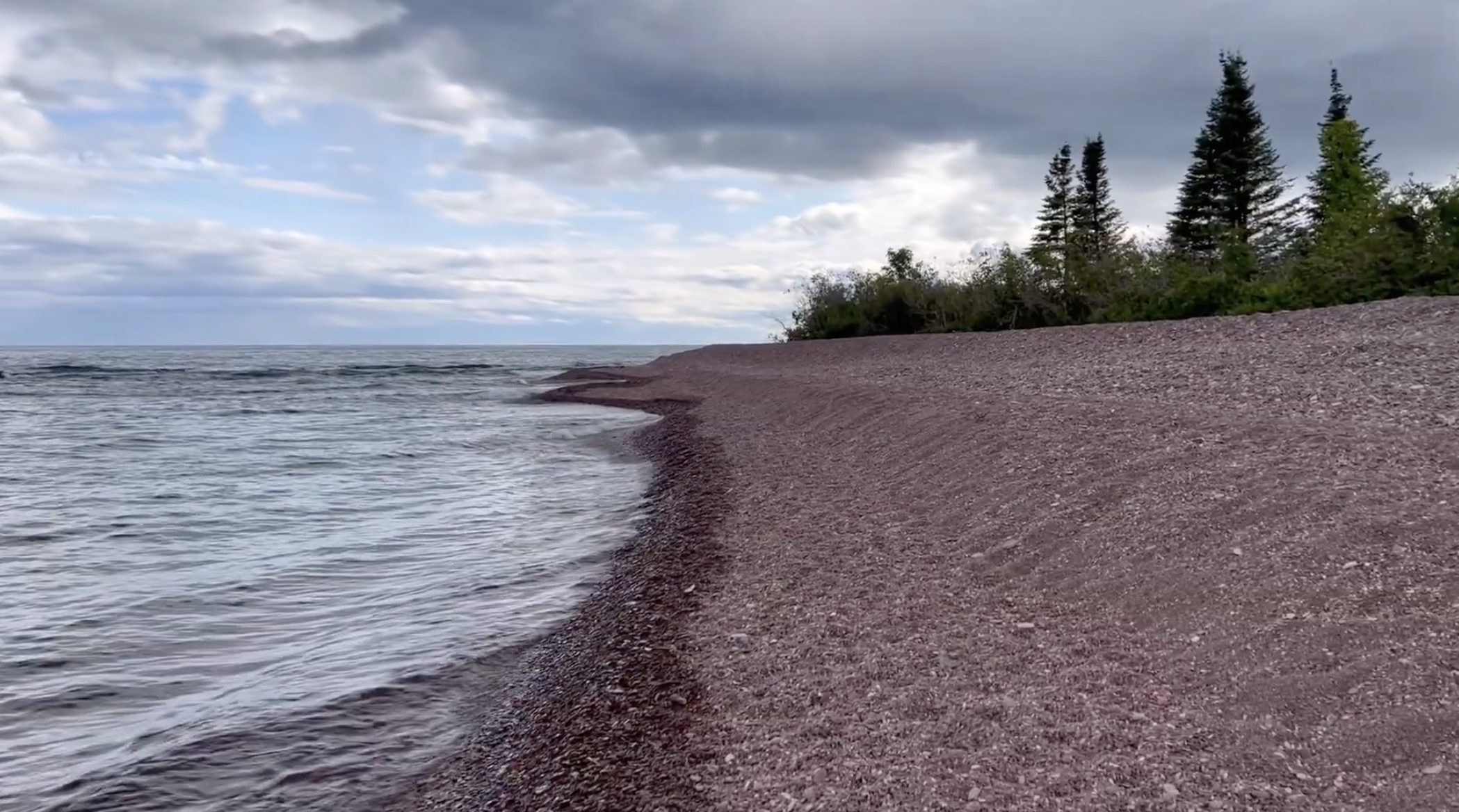 The beach is entirely rock here.  The waves have pushed it upwards to form these steep shelves.