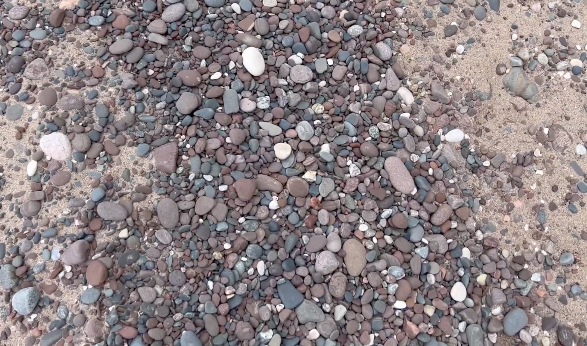 Here's what the mix of rocks down here looked like.  The beach was about half sand, half stone when I visited.  (That can change over time)