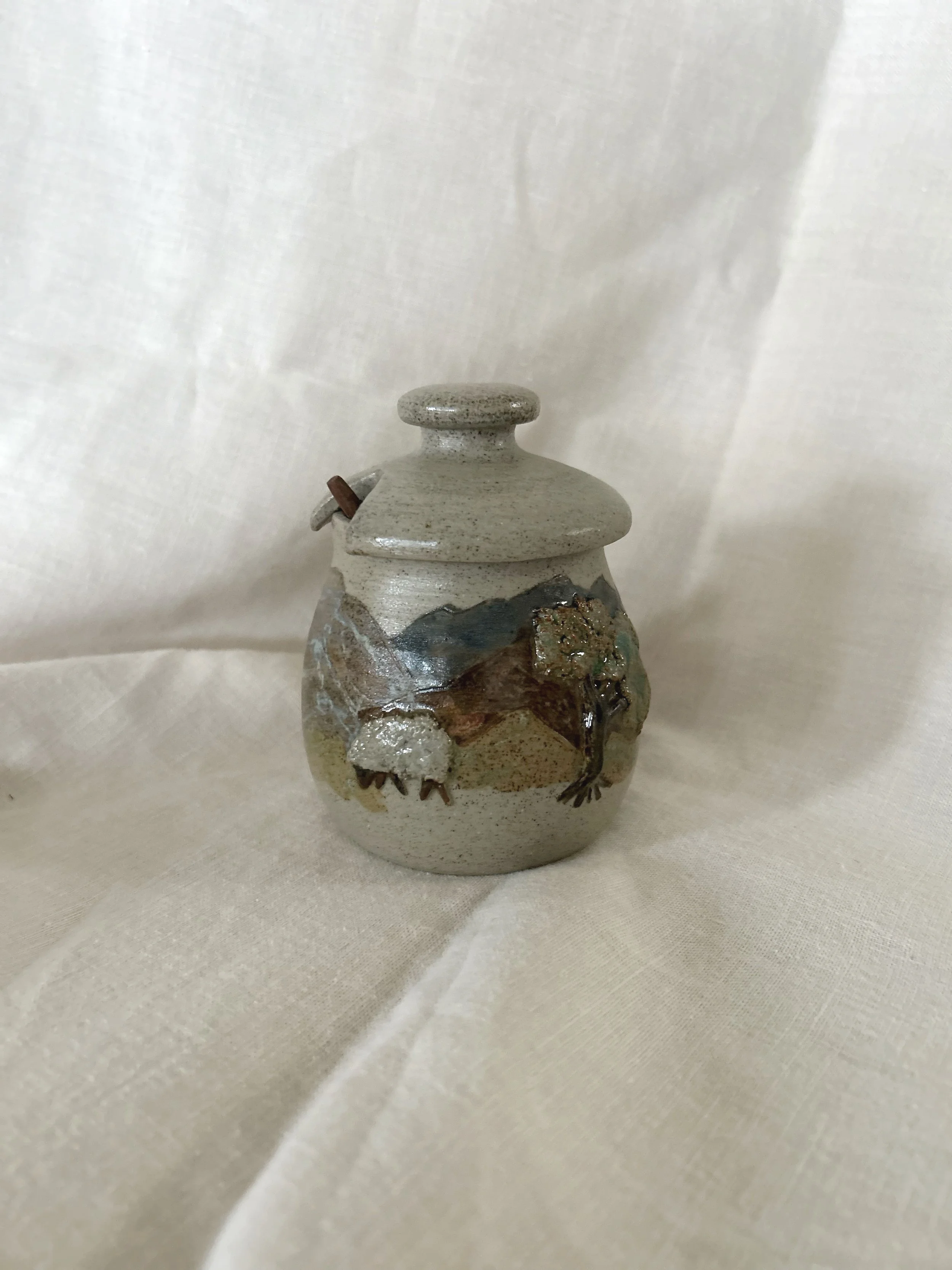 Handmade honey or sugar jar with wood spoon