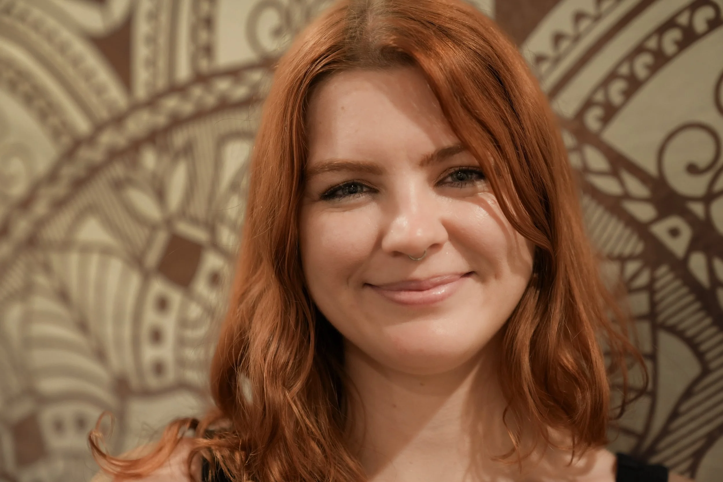 Maren smiling, closed lips, a close up.