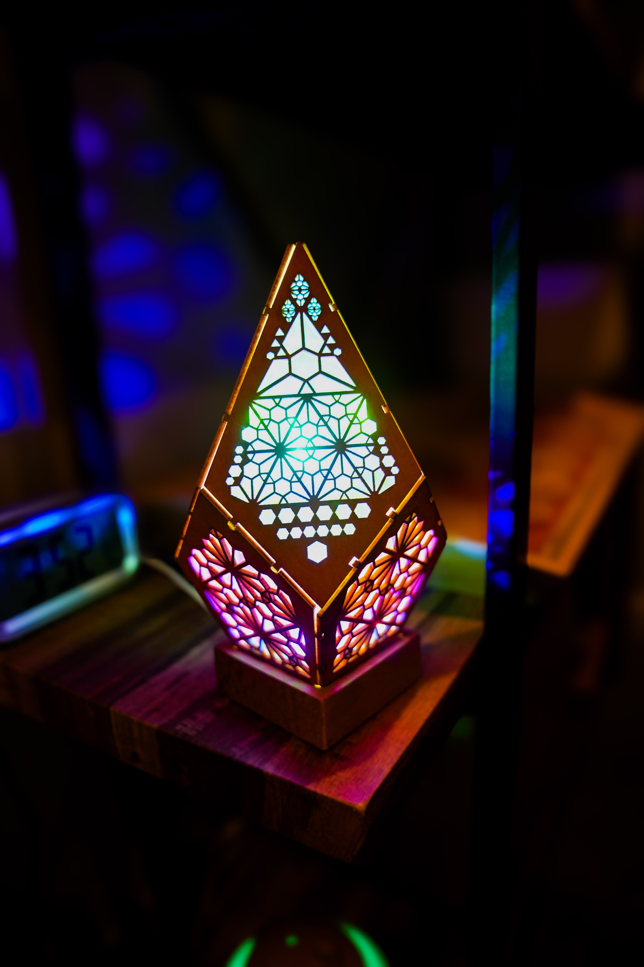 A 3D triangle shaped light with multiple colors in Maren's studio.