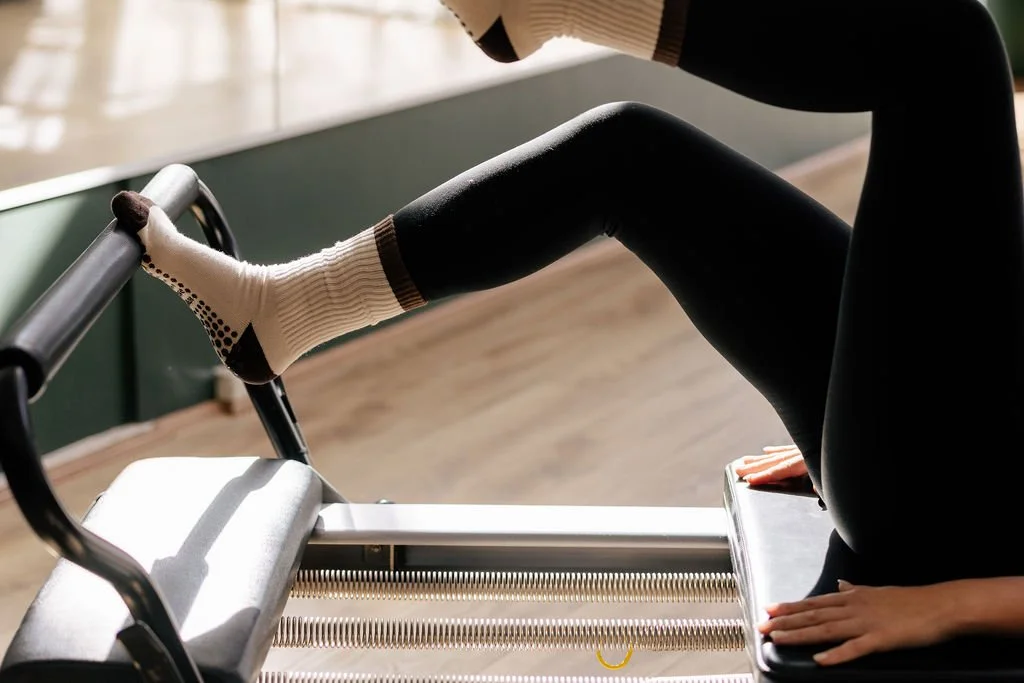 Single leg footwork on a Pilates reformer