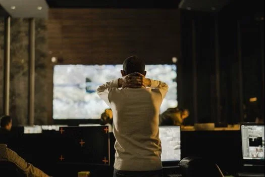 Man in crisis response centre watching events unfold