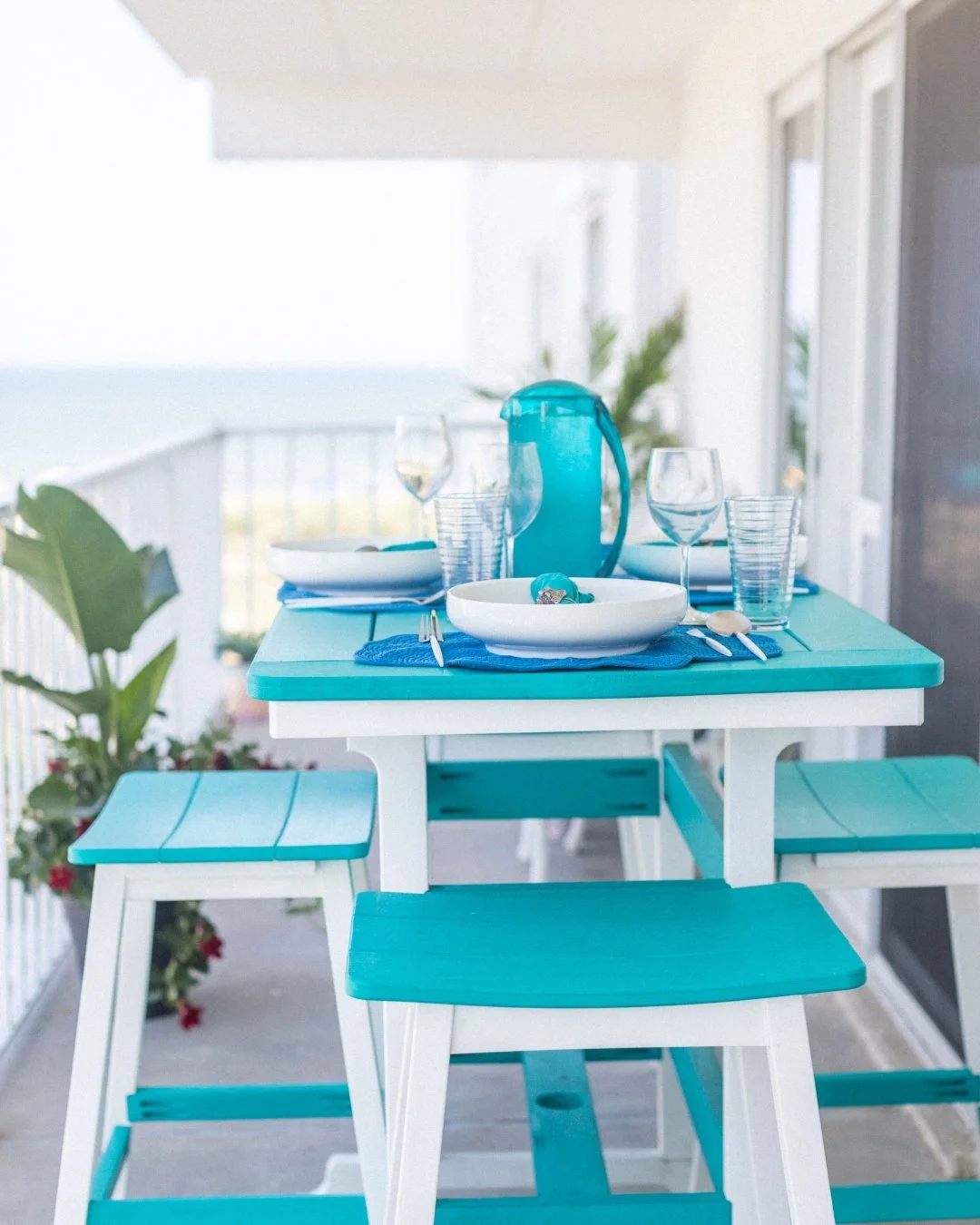 Breakfast on a balcony where you can see the water changes what a table needs to do.

This is the outdoor dining setup we did at an Ocean City condo, a space designed around the fact that the view is doing most of the work. When the backdrop is that 