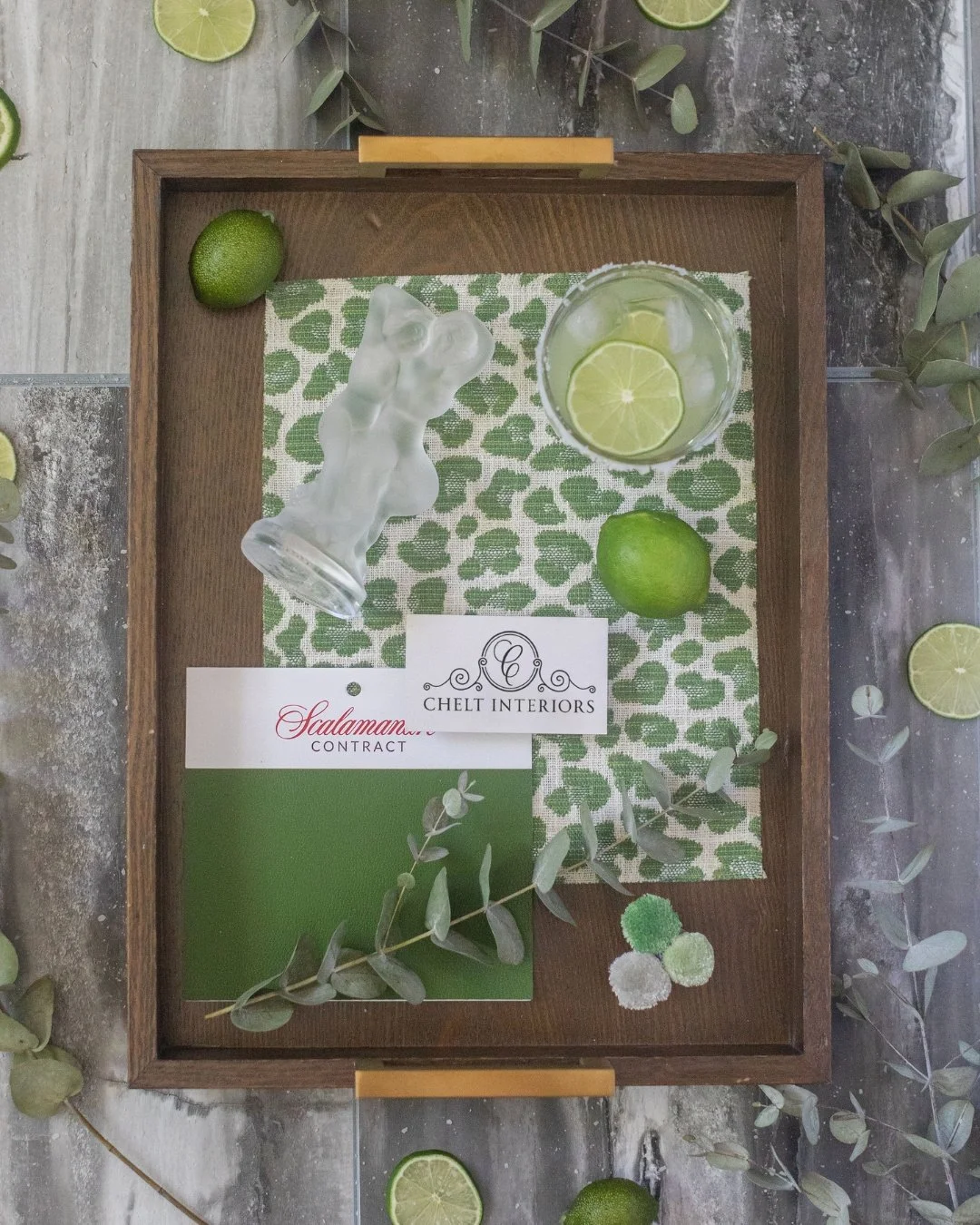 Every project starts with a tray like this one: samples pulled together, a card with our monogram tucked in the corner, nothing decided yet.

This particular pairing, a leopard print napkin against a bright lime, is the kind of combination a lot of c