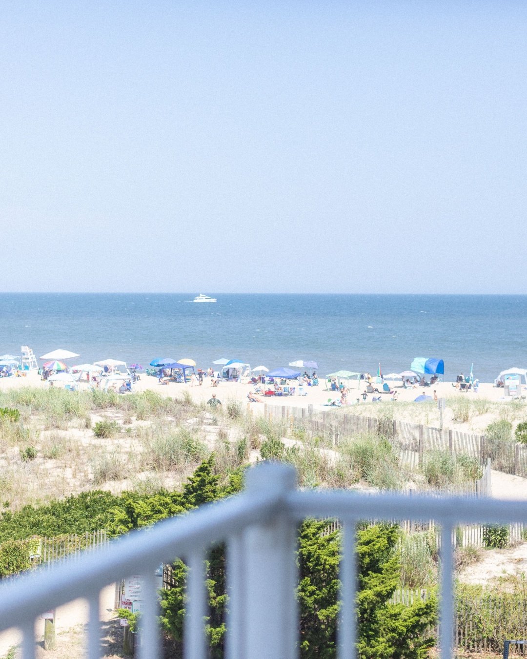 A great room does not need much when the view is doing this much work.

From this balcony, the ocean is essentially another wall, and one of the most important decisions in the whole condo was making sure nothing inside competed with it. Window treat