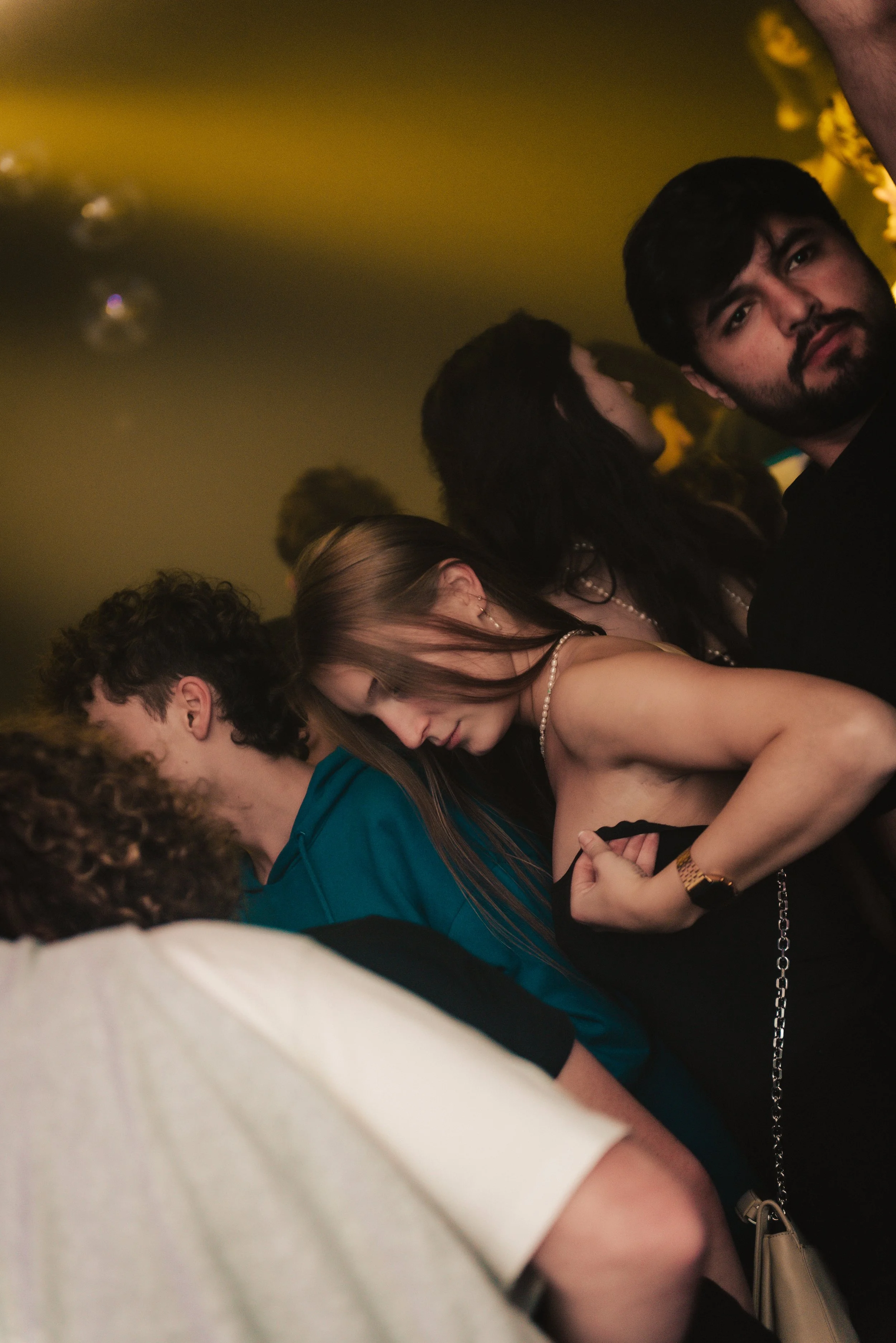 People dancing in a dimly lit club with a party atmosphere.